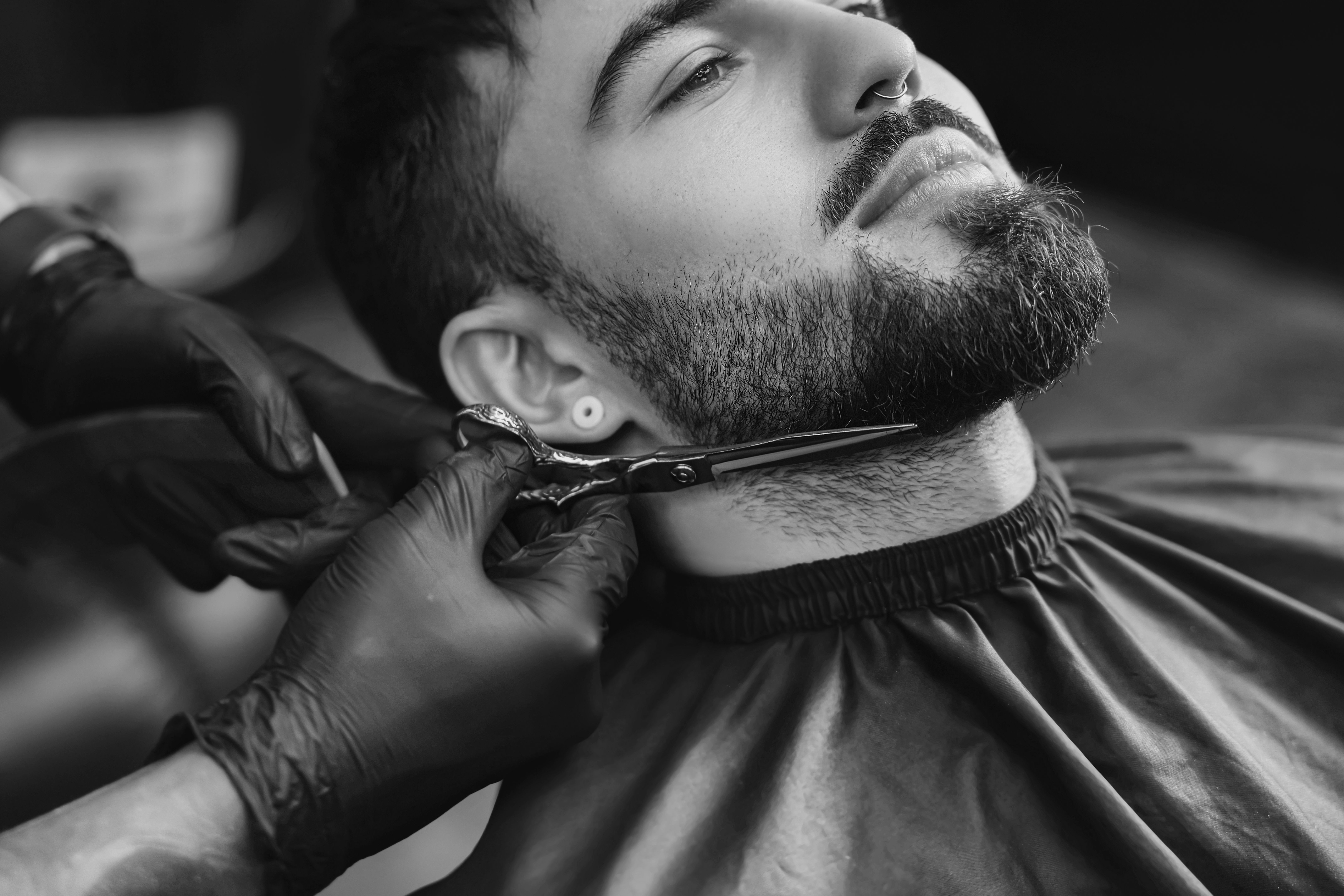 barber trimming beard