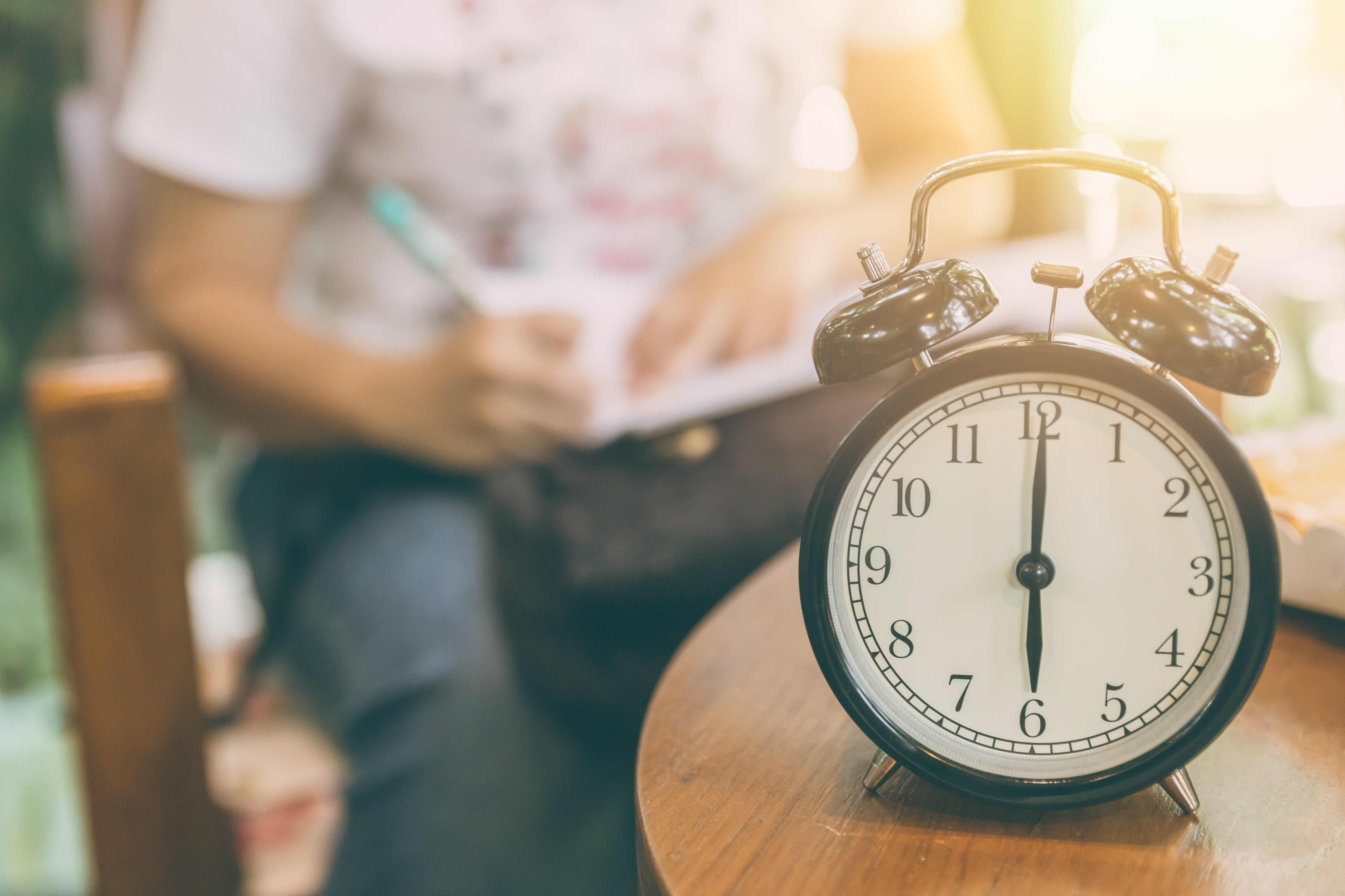 time for working concept. clock timed at 8 o'clock with blur working people background.