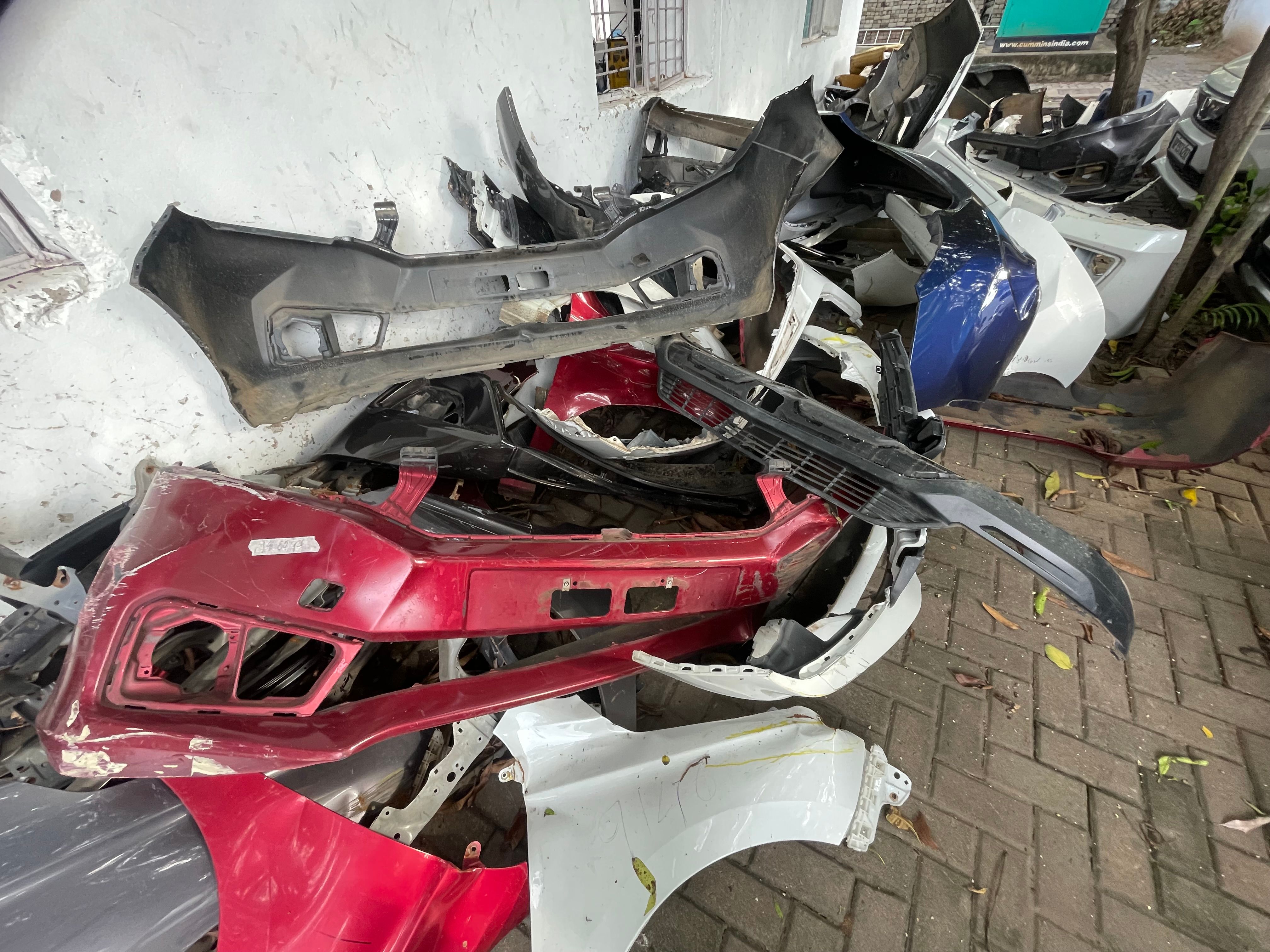 Scrap Car Bumpers Piled Up for Recycling and Auto Parts