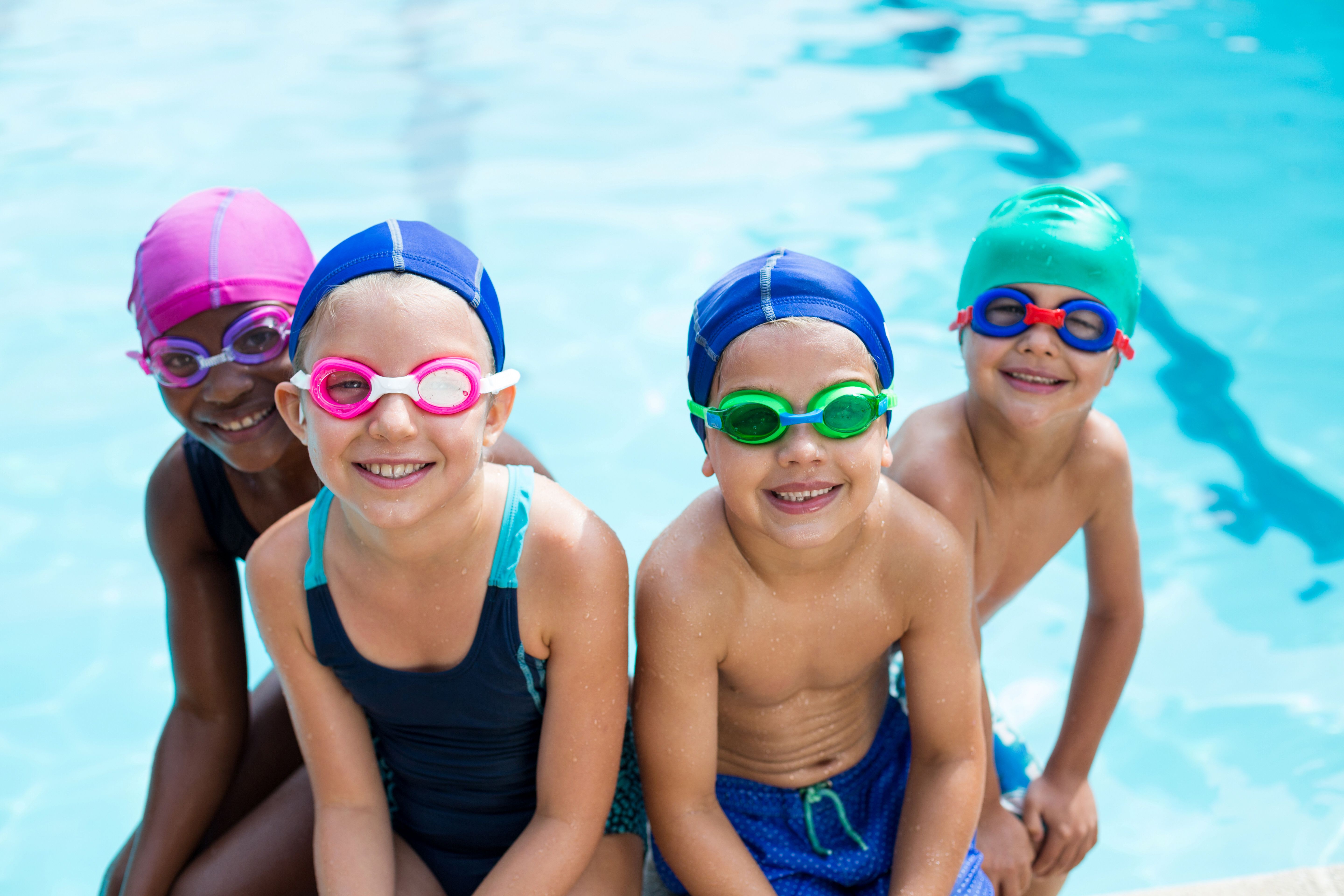 Little swimmers sitting at poolside Little swimmers sitting at poolside