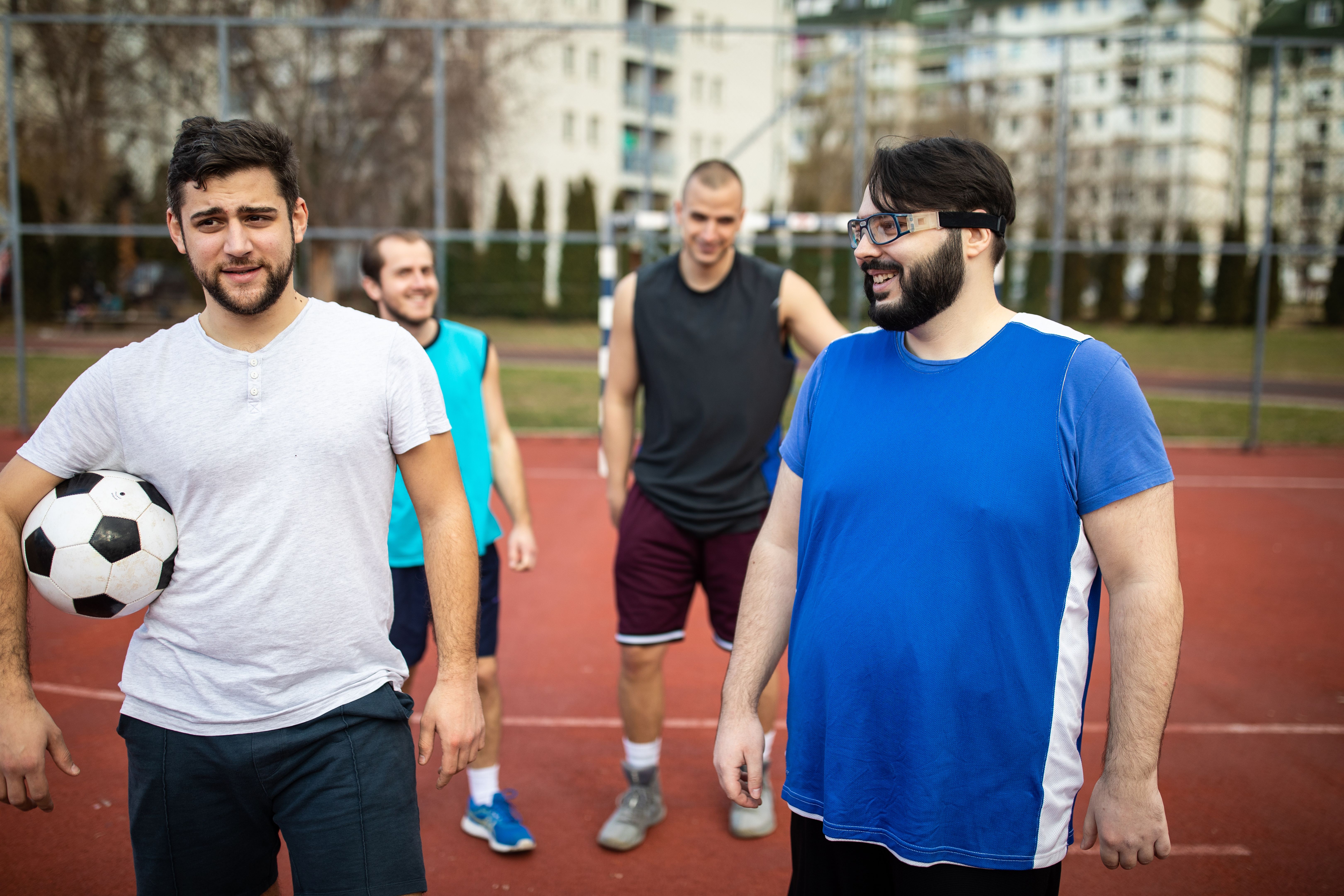 Friends preparing for soccer match on outdoor soccer court Friends preparing for soccer match on outdoor soccer court
