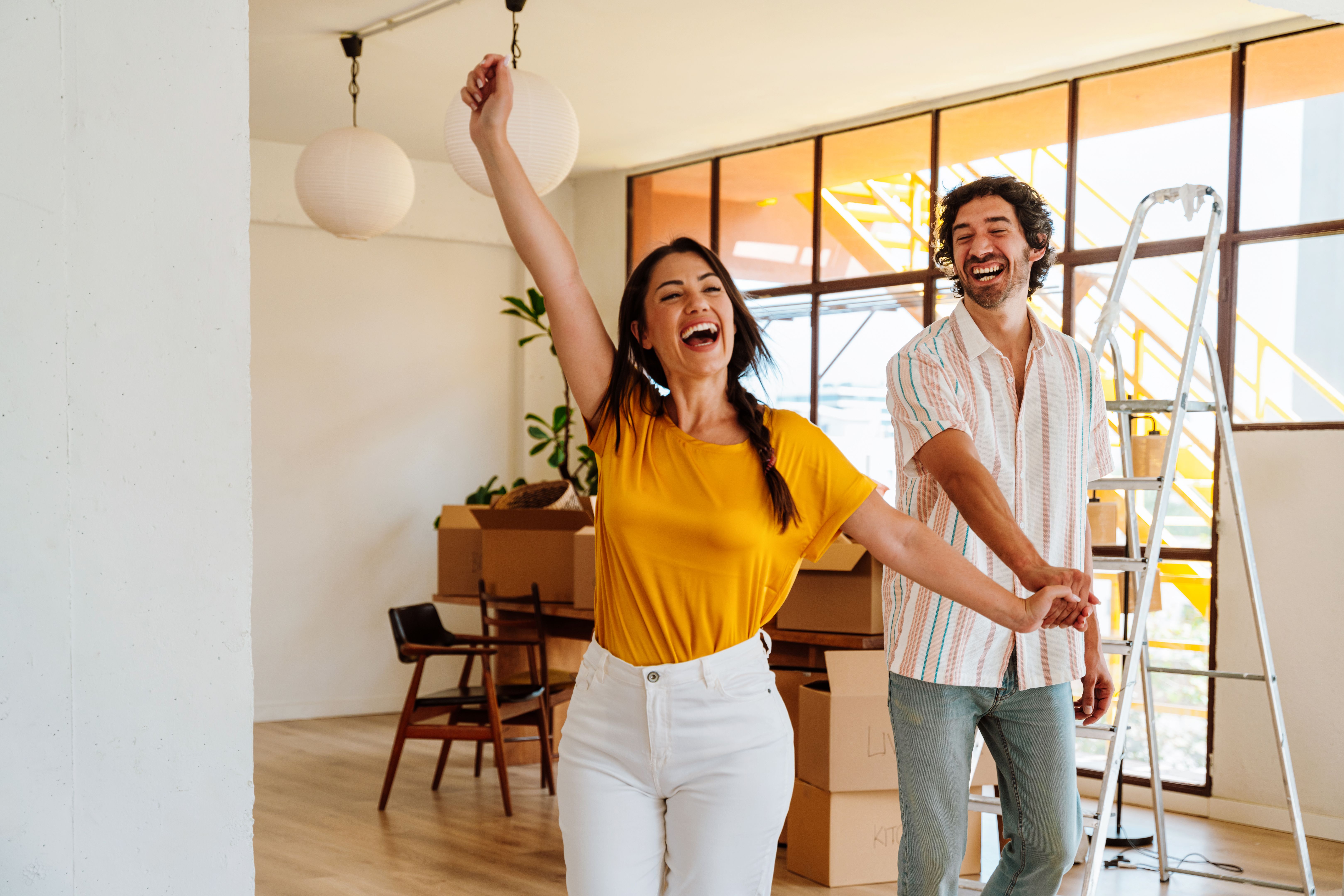 Happy young couple relocating in a new apartment. Happy young couple relocating in a new apartment.