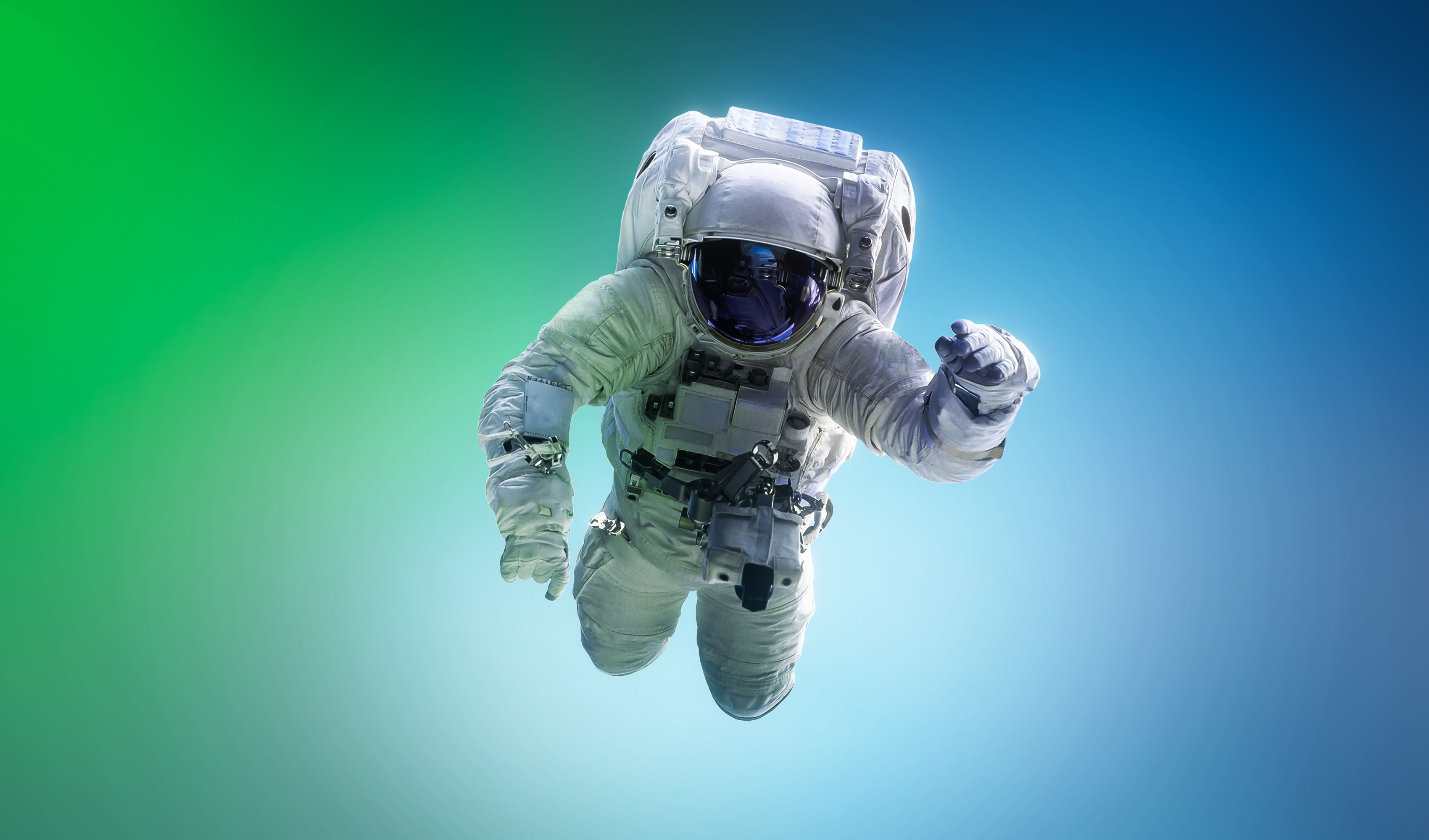 Spaceman floating in space. Astronaut on bright blue and green background. Man in space suit fly. Sci-fi wallpaper. Graphic design space concept. Mixed media