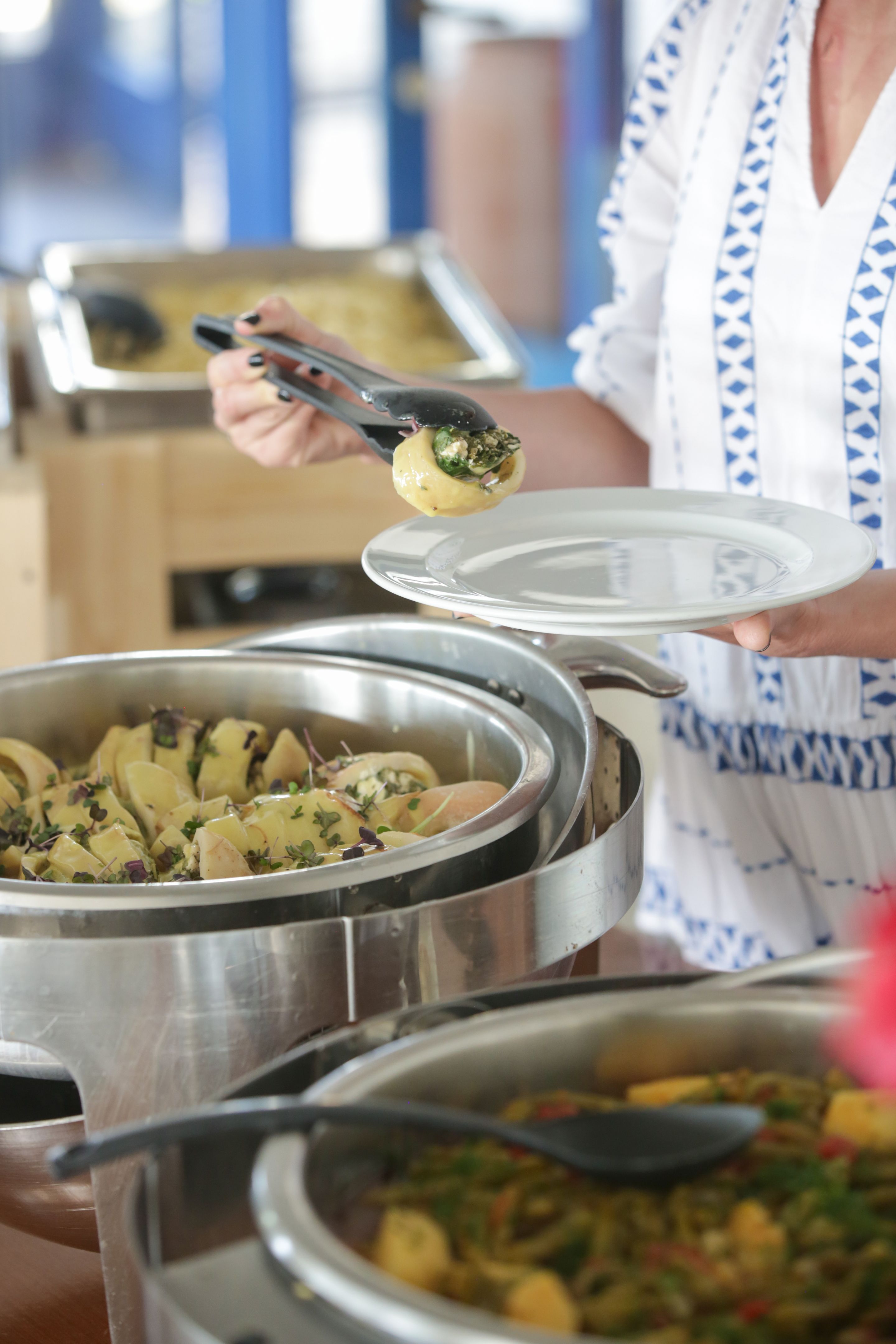 Woman taking food from a buffet line Woman taking food from a buffet line