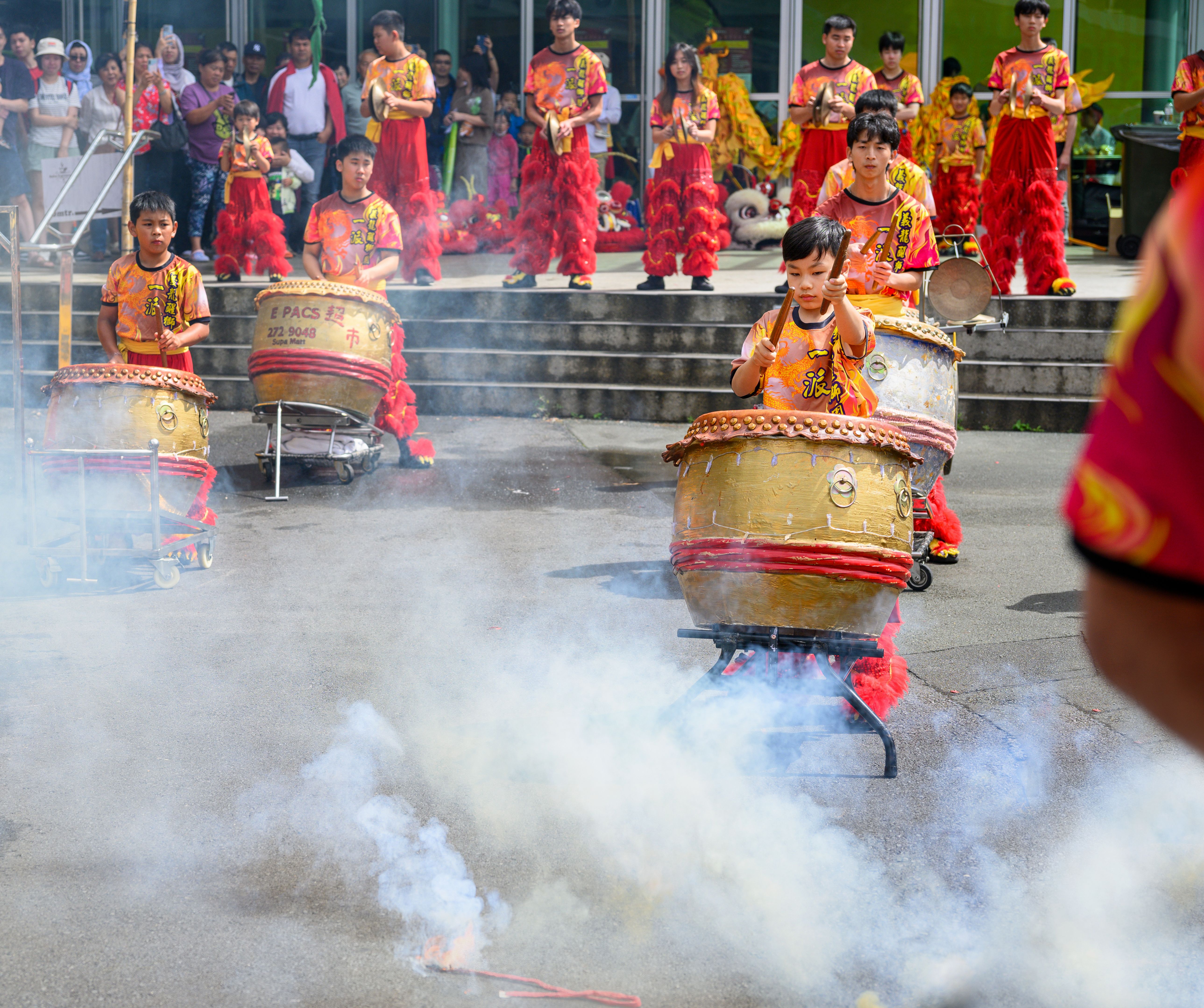 Children playing drums to celebrate Chinese New Year. Free to public street performance.