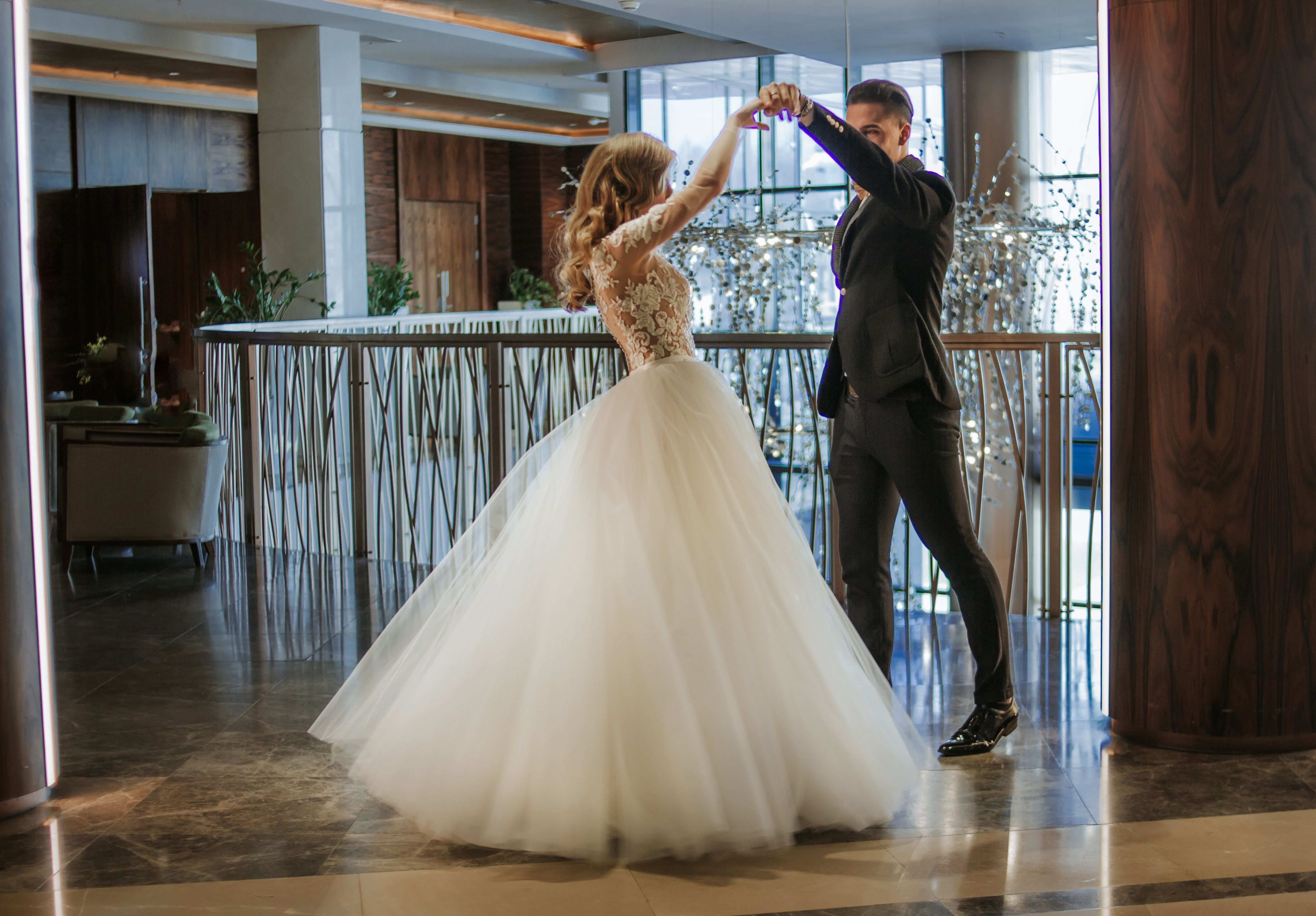 A young couple is dancing at a ball. Ballroom dance. Romantic couple of newlyweds first elegant dance at wedding. A young couple is dancing at a ball. Ballroom dance. Romantic couple of newlyweds first elegant dance at wedding.