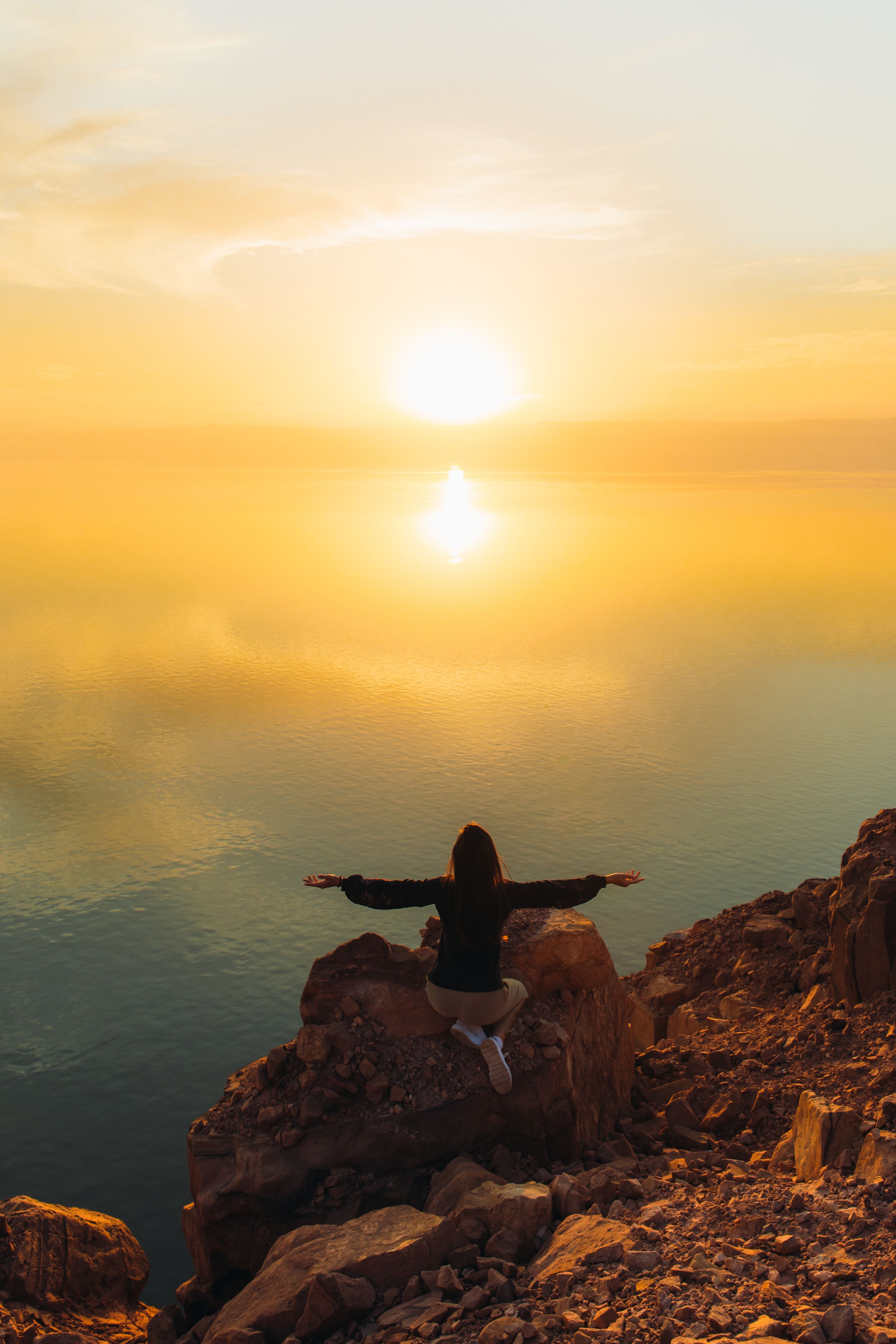 woman contemplating the scenic sunset above the Dead Sea in Jordan