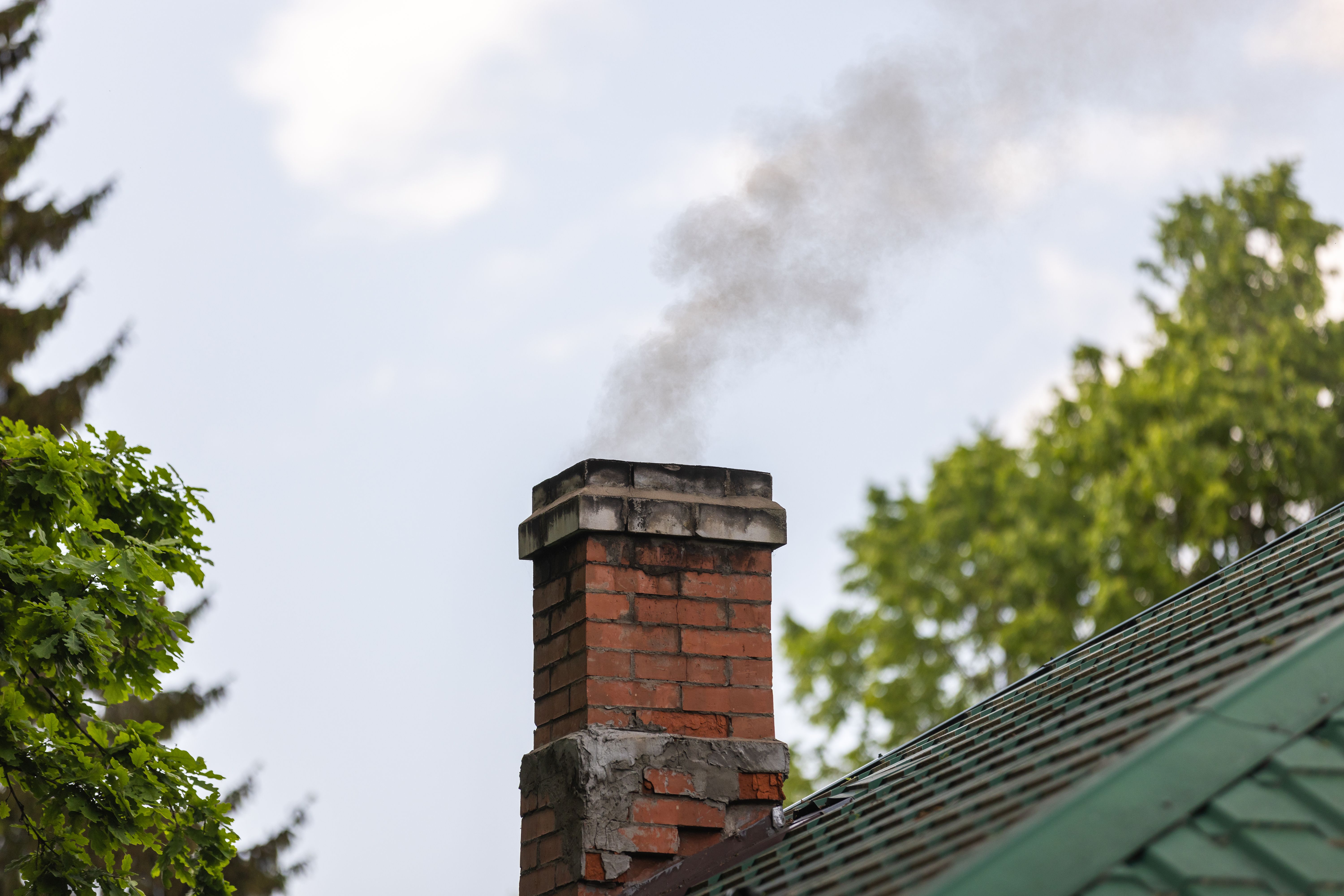Brick chimney over green-tiled DC rowhouse roof