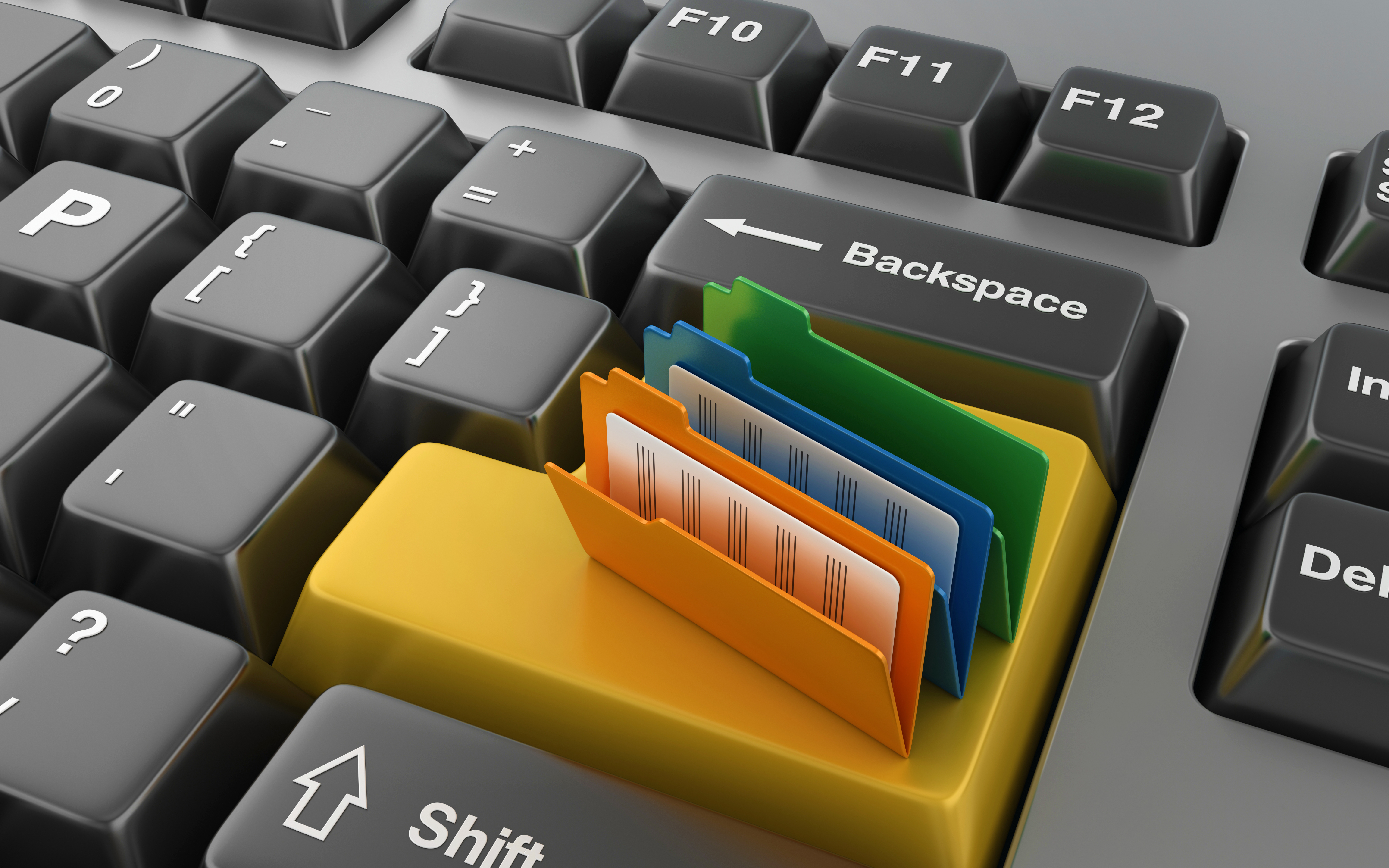 A computer keyboard with colorful digital folders scattered across it, representing the need for organisation and efficient document management.