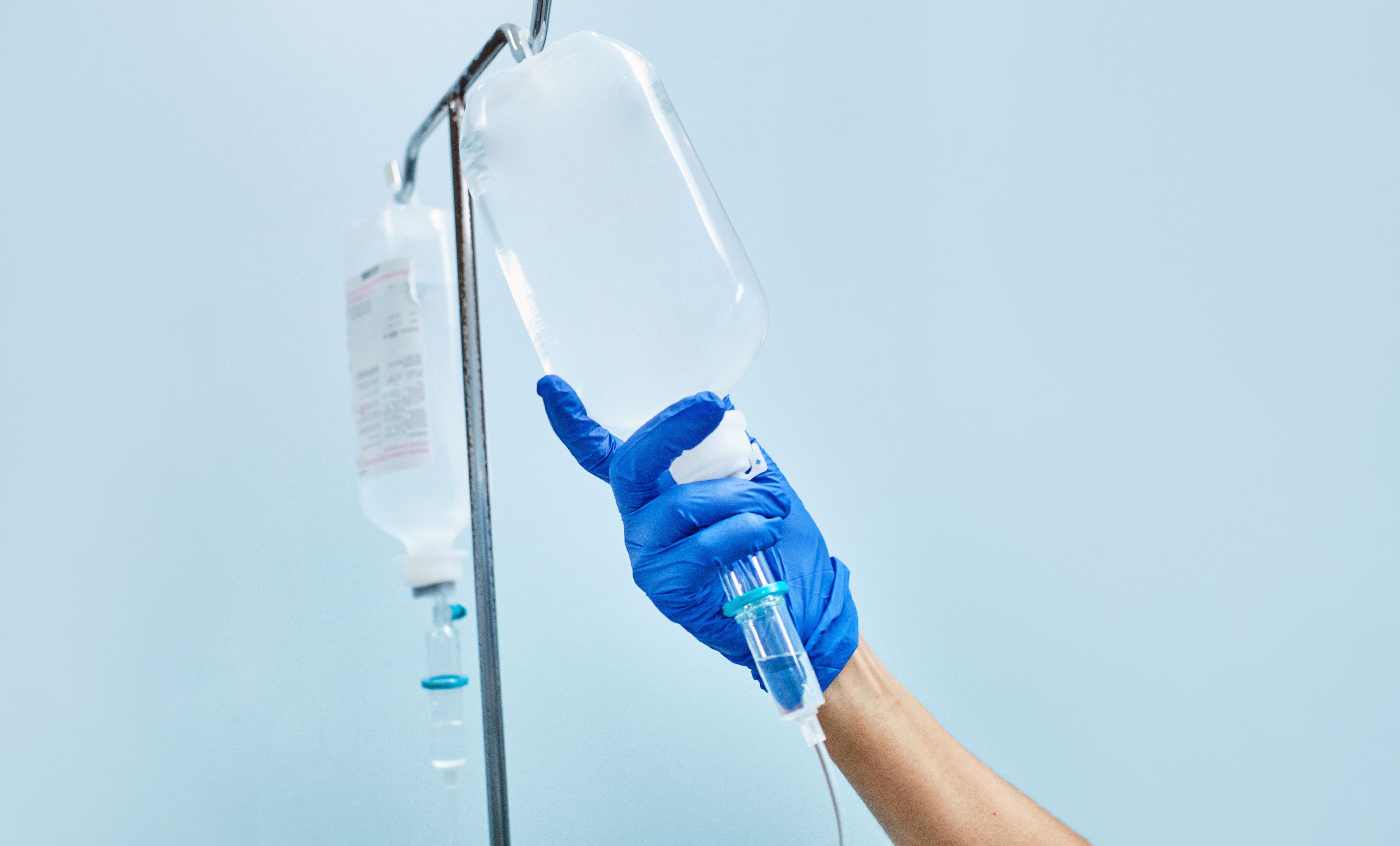 nurse's hand preparing an intravenous drip nurse's hand preparing an intravenous drip