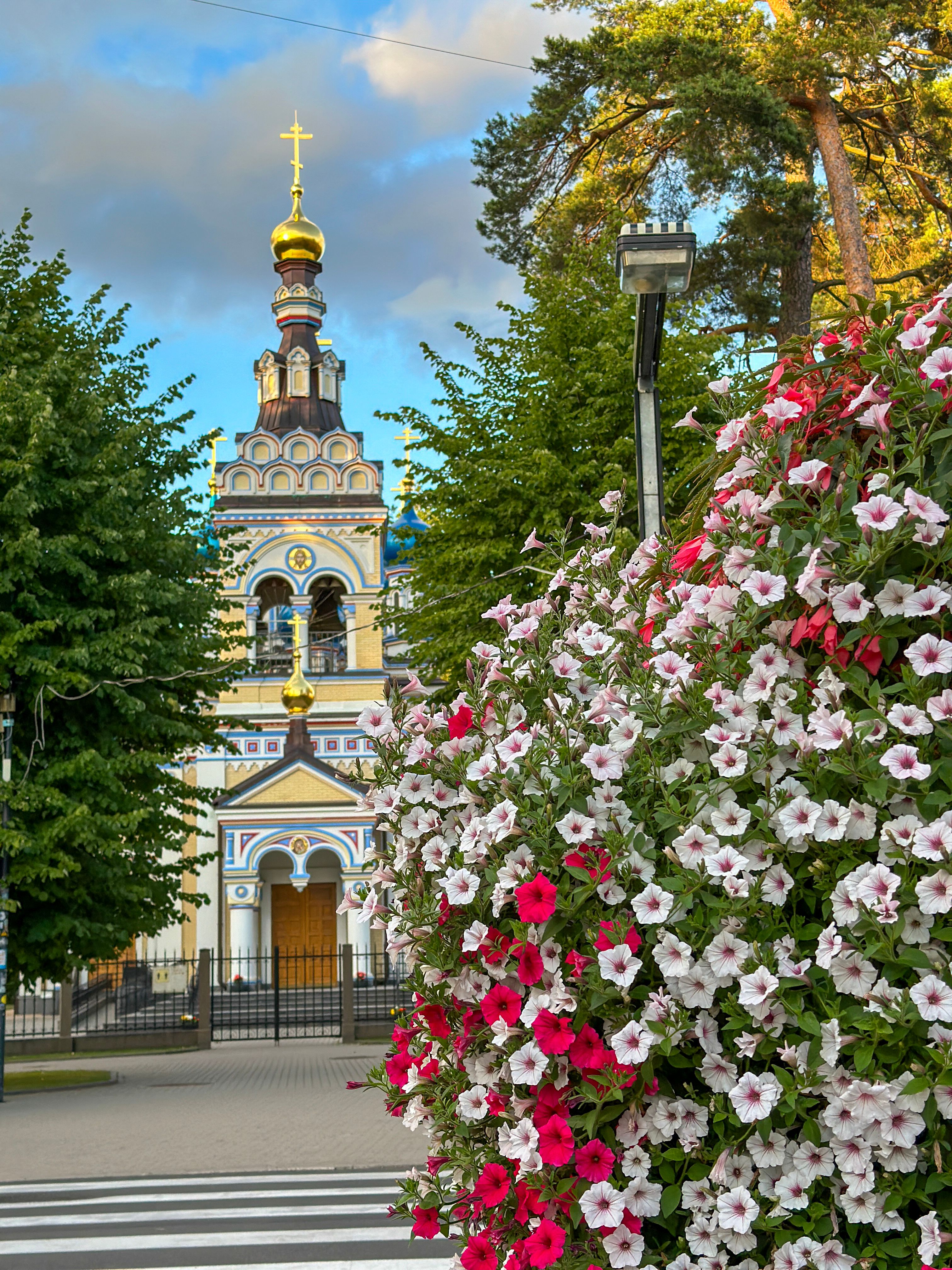Flowers lead the way to the gorgeous Church of Our Lady of Kazan in Jurmala, Latvia