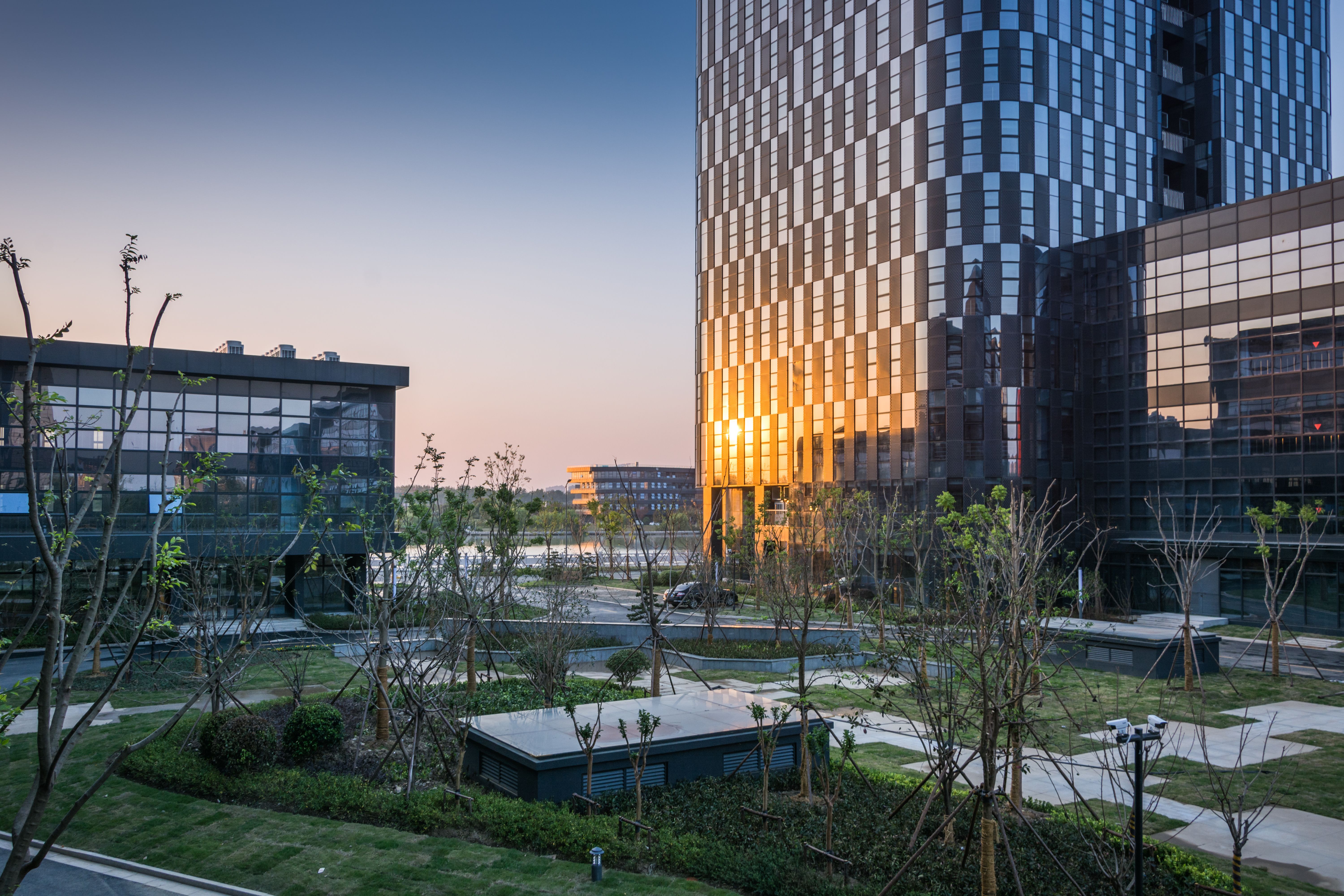 Stunning Urban Sunset Reflection in Modern Architecture with Green Spaces Stunning Urban Sunset Reflection in Modern Architecture with Green Spaces
