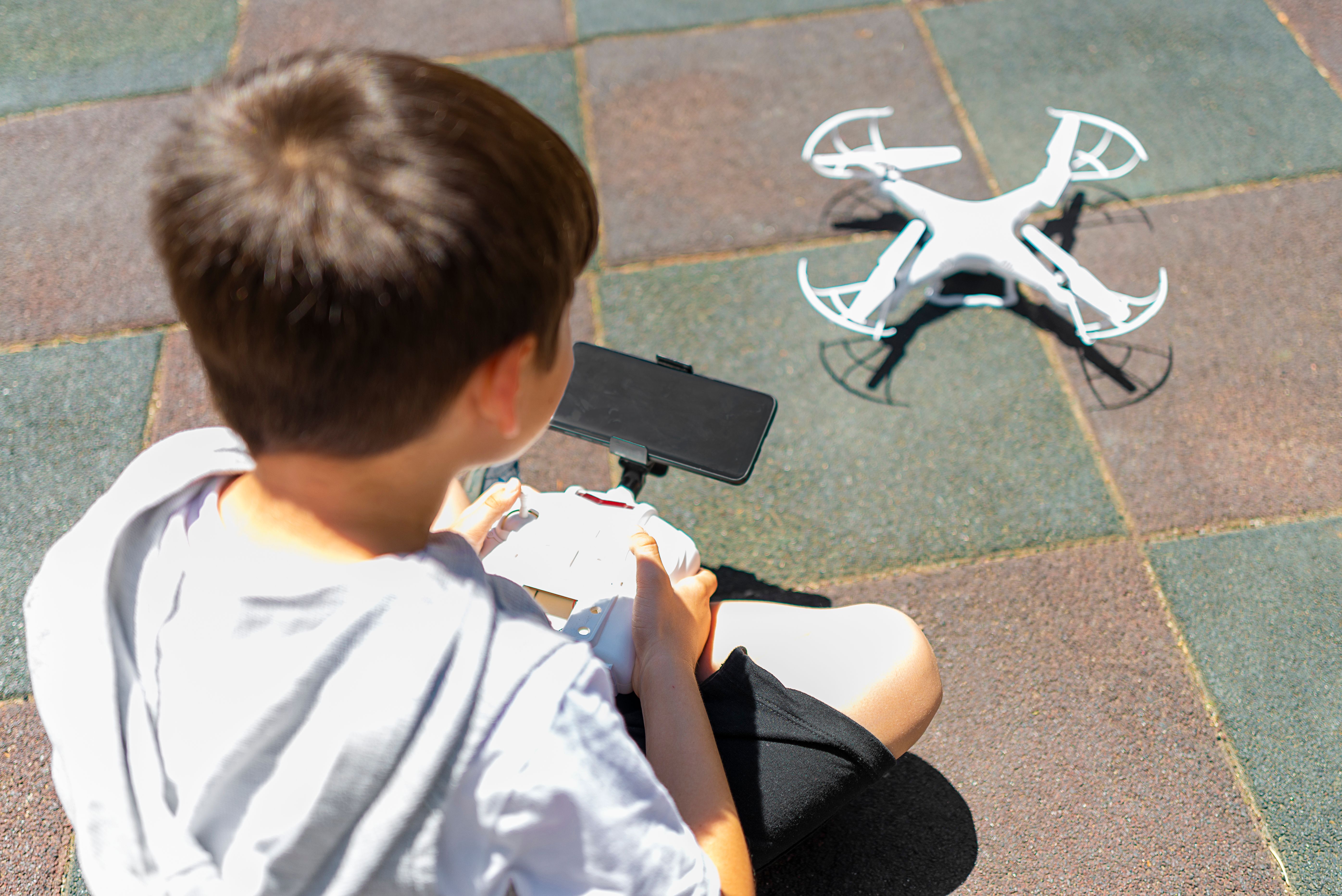 children flying drones