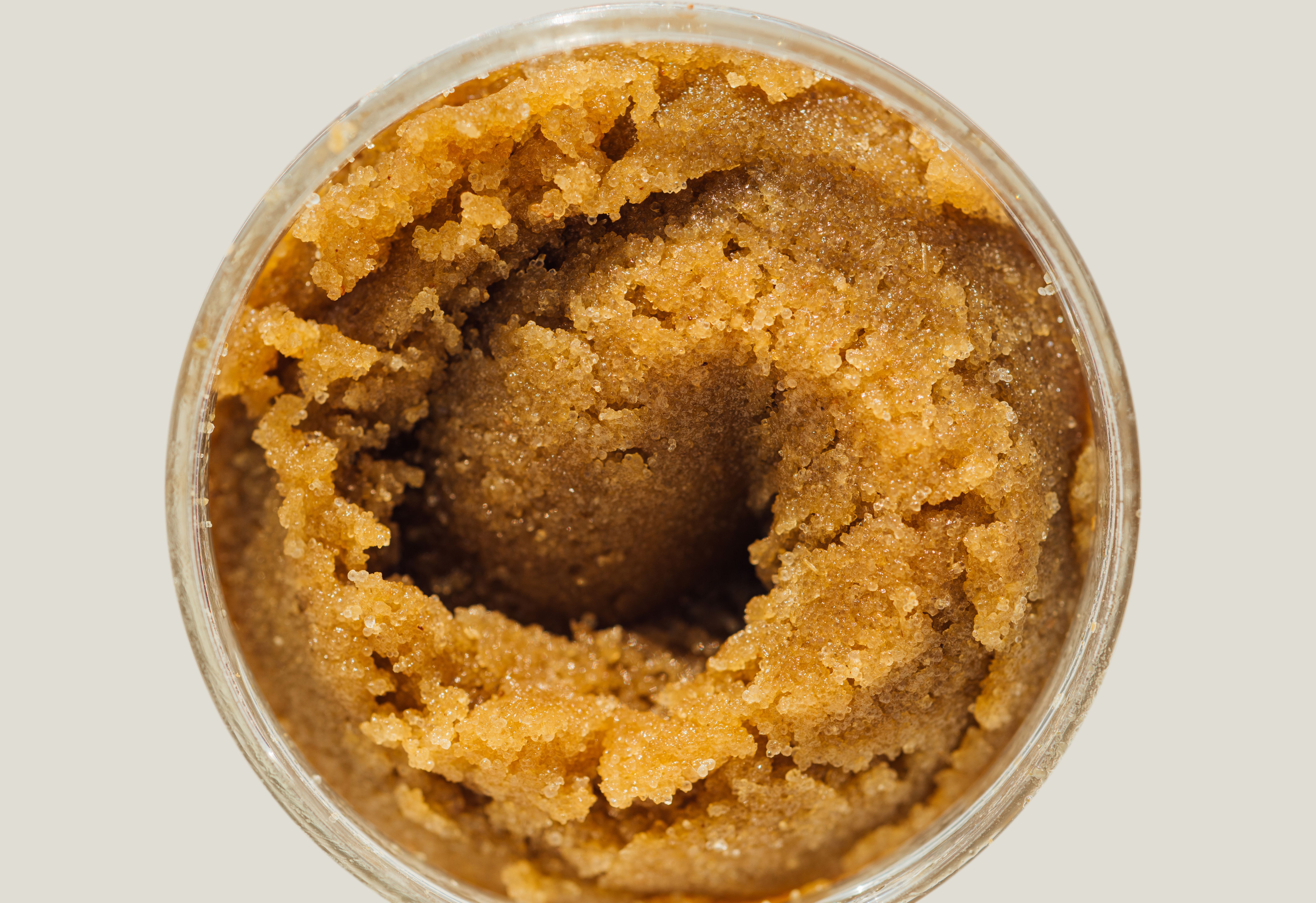 Texture of handmade cane sugar scrub in a round jar