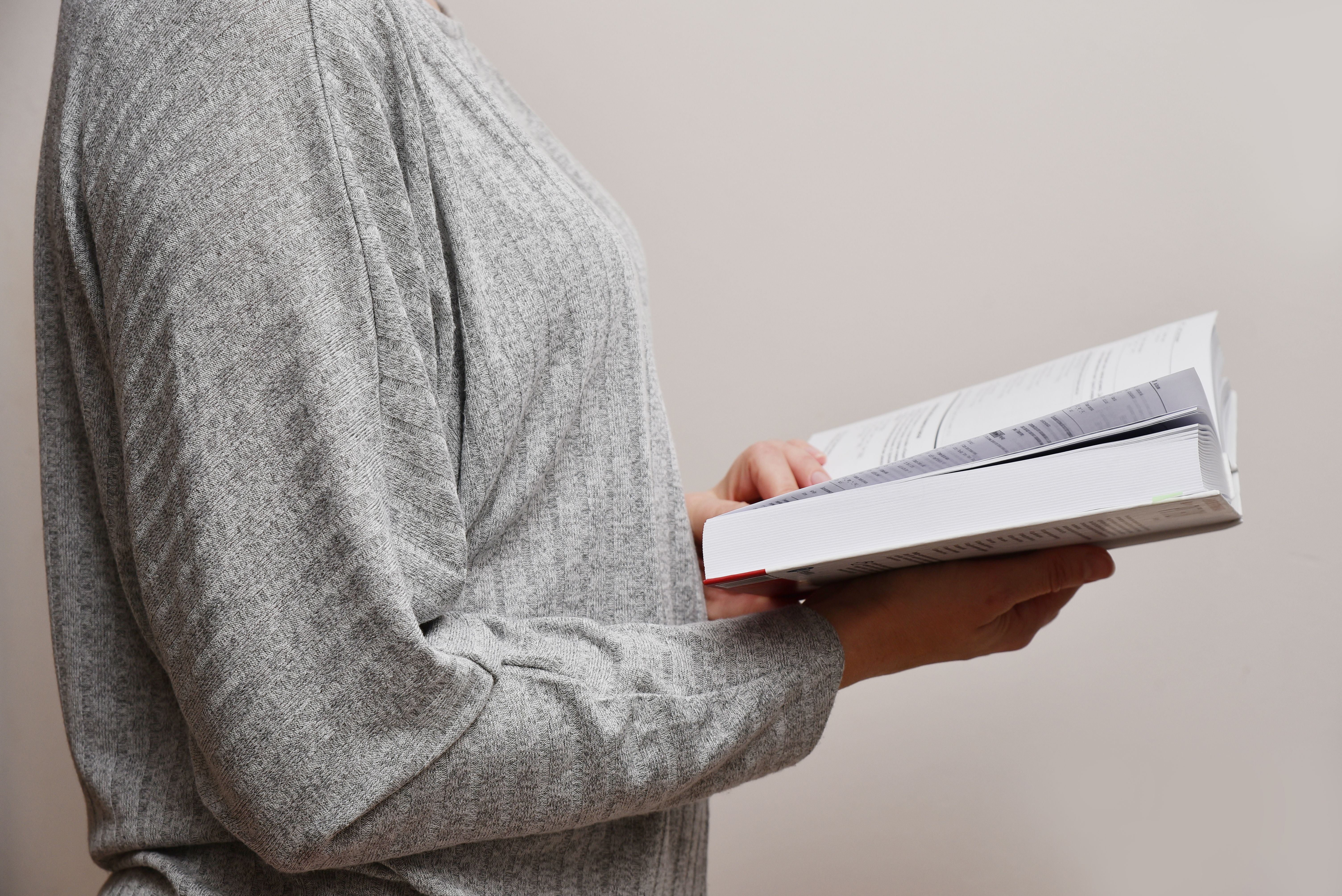 Woman reading a book side view