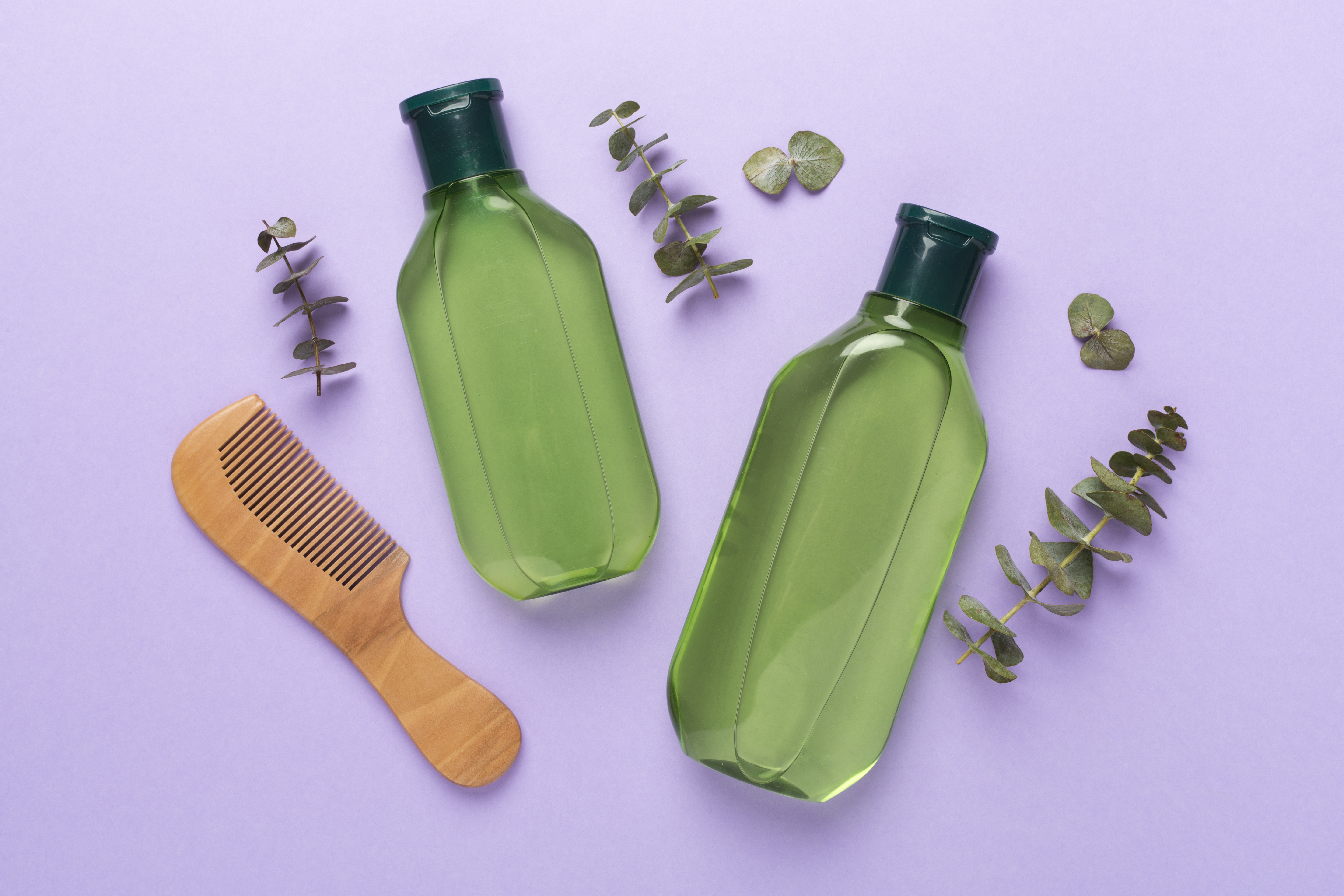 Herbal shampoo and conditioner and comb on color background, top view Herbal shampoo and conditioner and comb on color background, top view