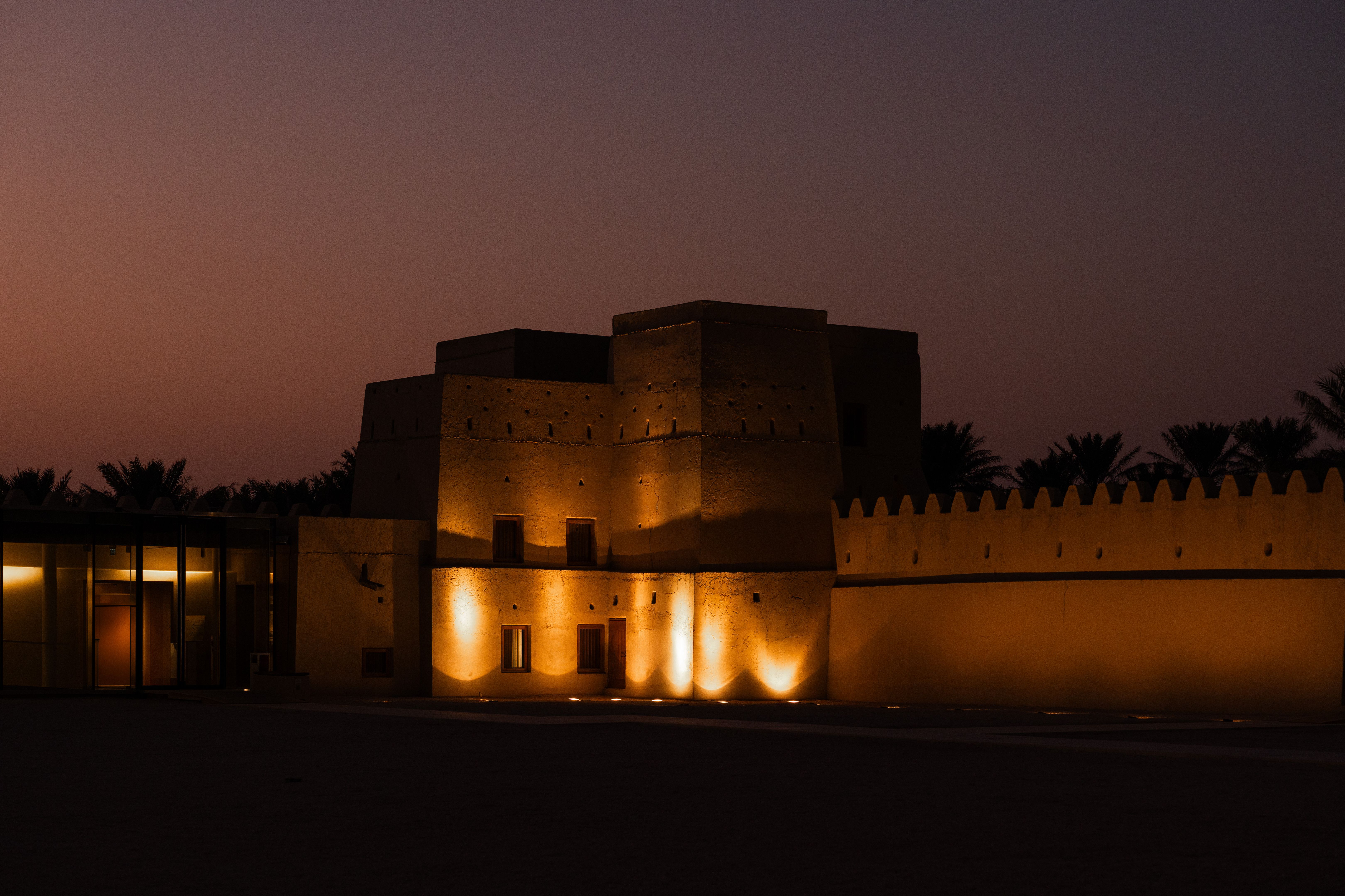 Sheikh abdullah bin jassim al thani palace glowing at dusk in doha, qatar