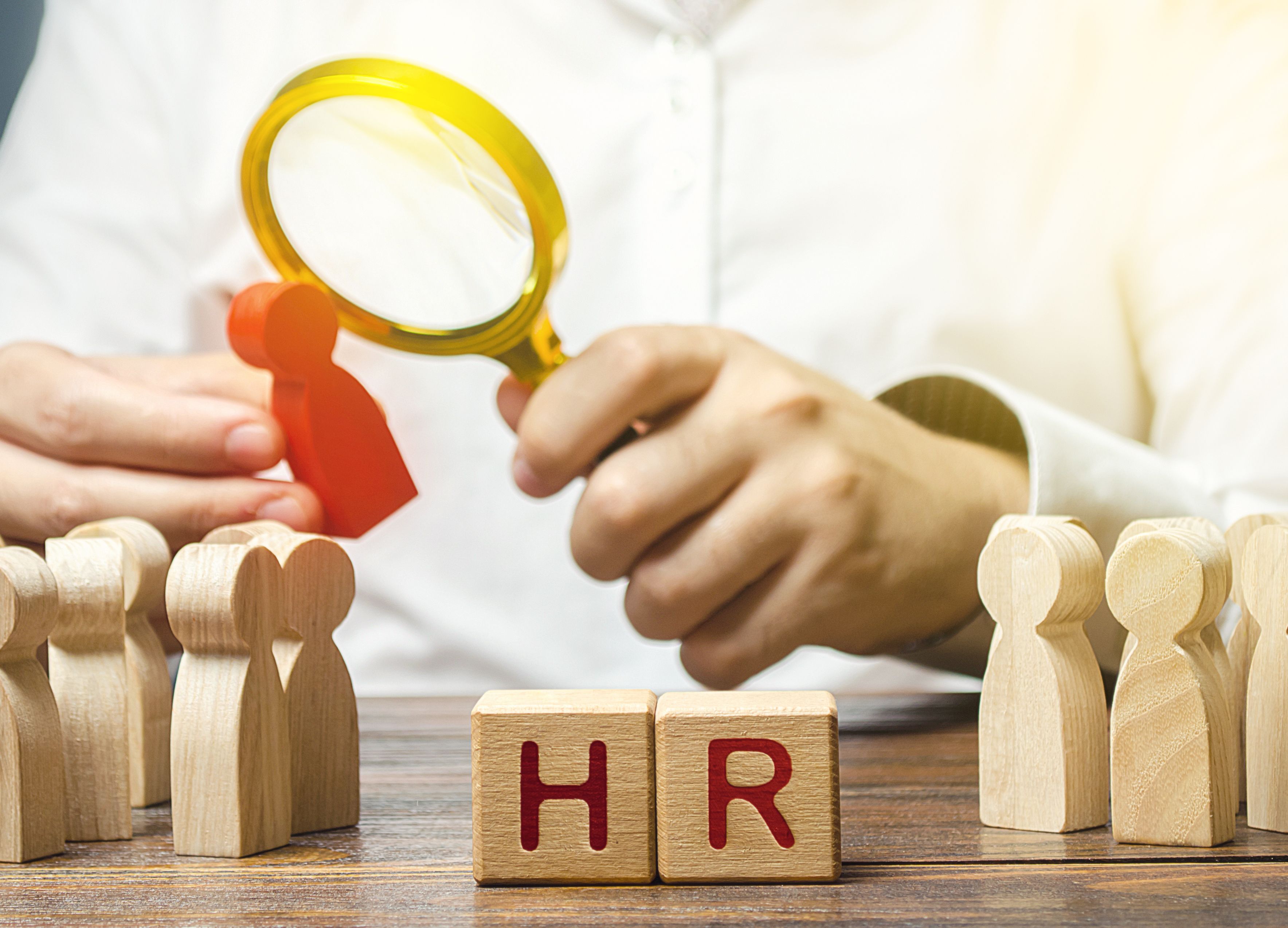 Men employer examining a potential employee candidate with a magnifying glass. Recruiting new workers, headhunters Human resources. Search for talented worker. Checking skills qualities. Hiring