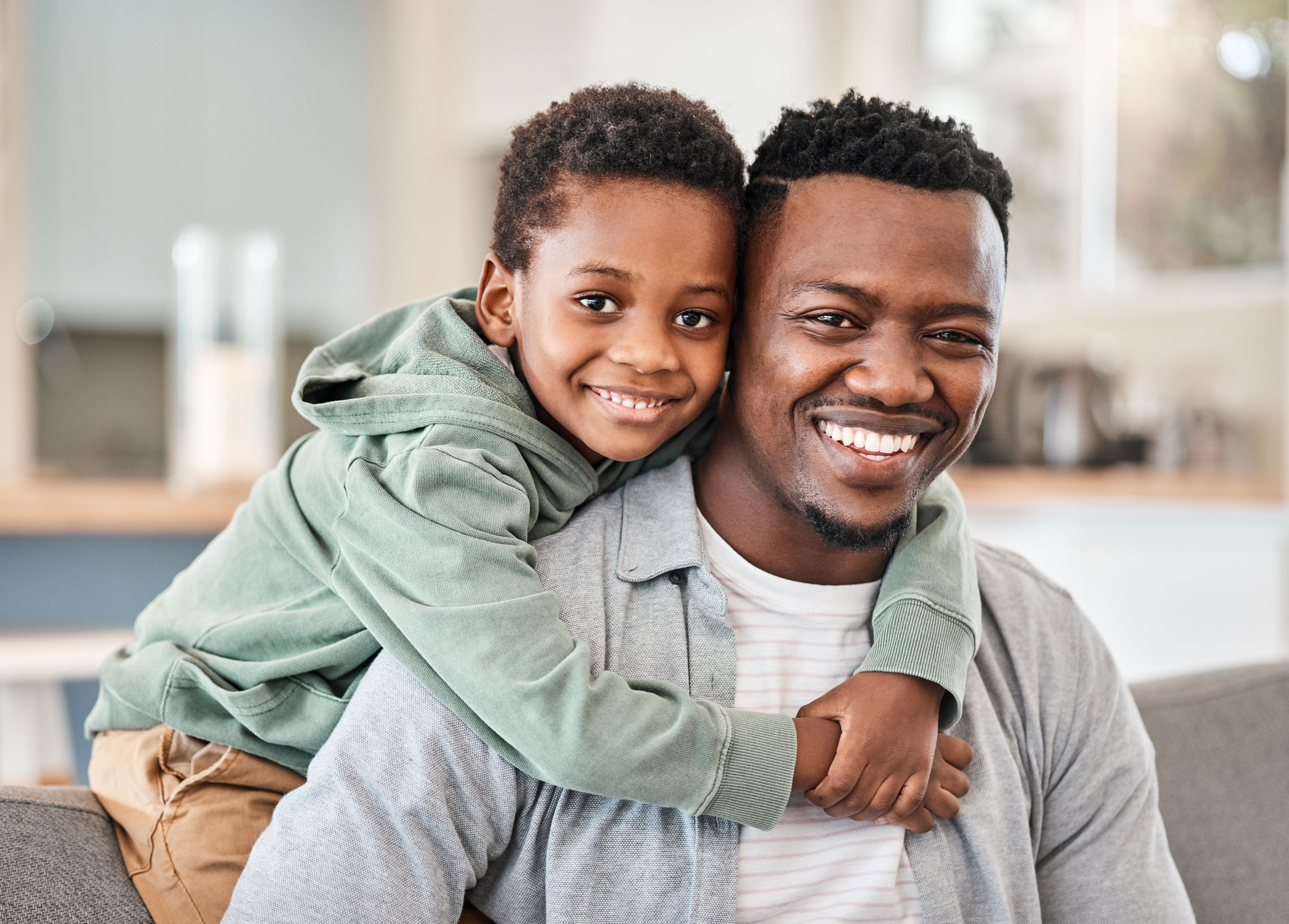 Shot of an adorable little boy spending quality time with his father on the sofa at home Shot of an adorable little boy spending quality time with his father on the sofa at home