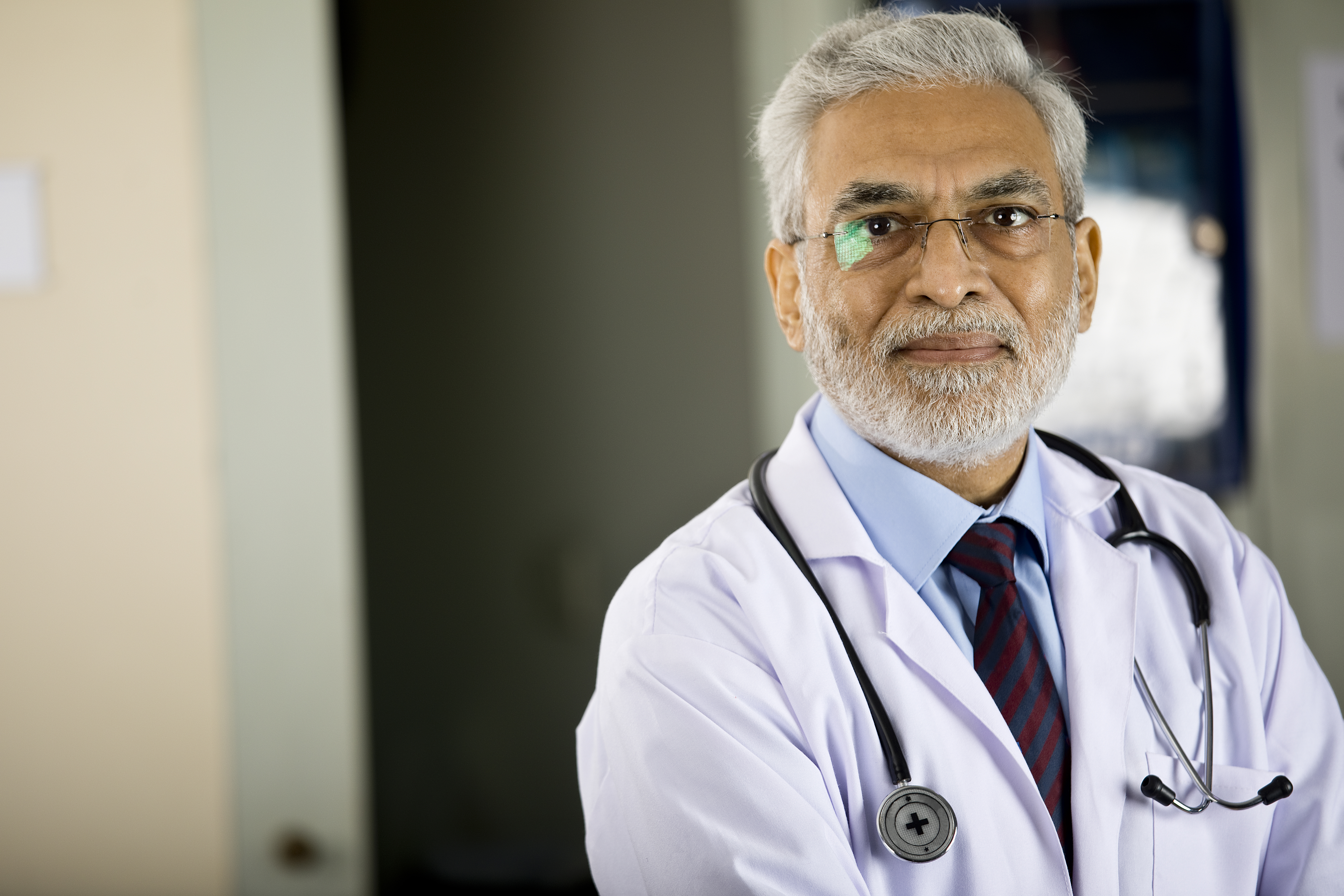 Senior male doctor looking at camera