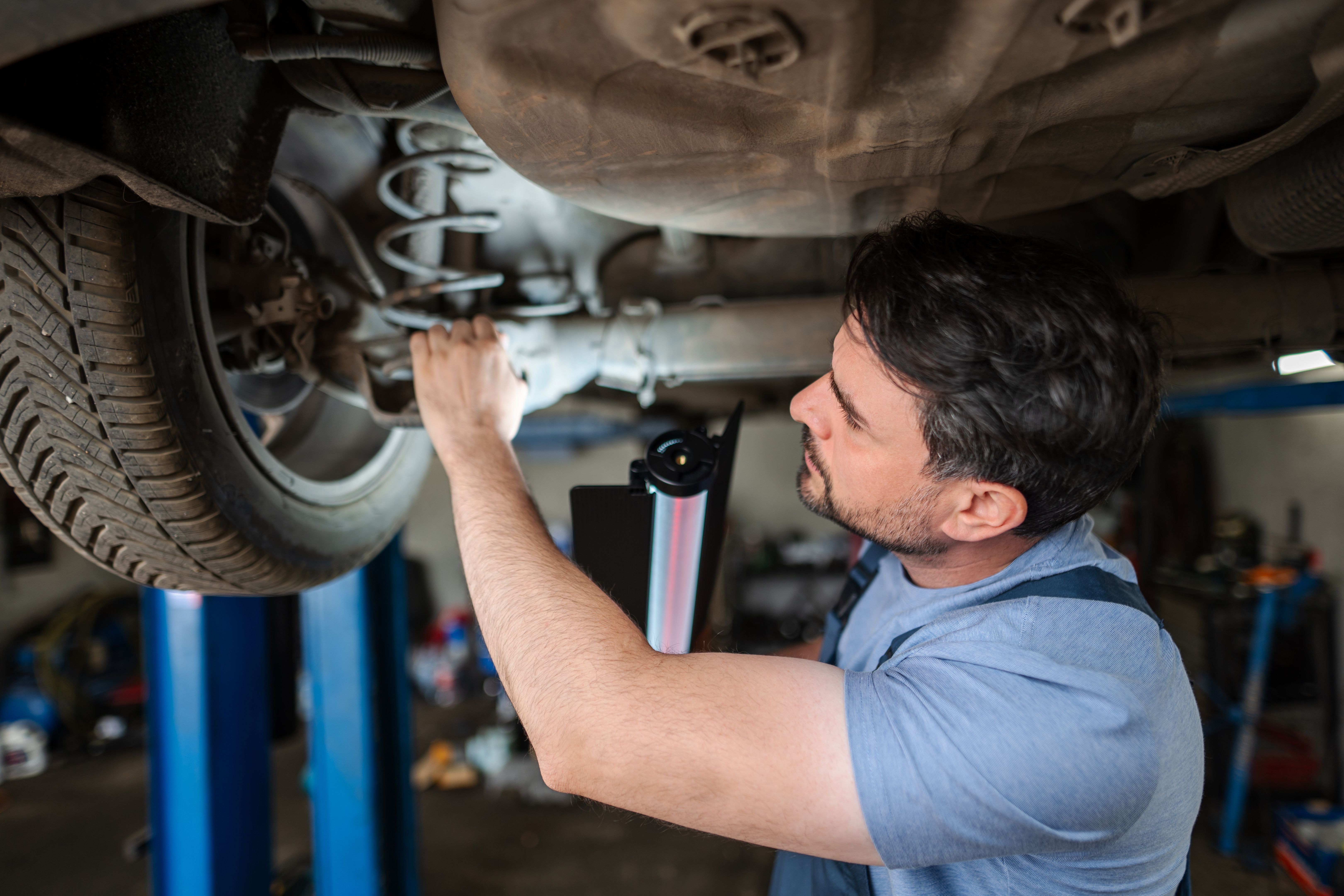 mechanic checking brakes
