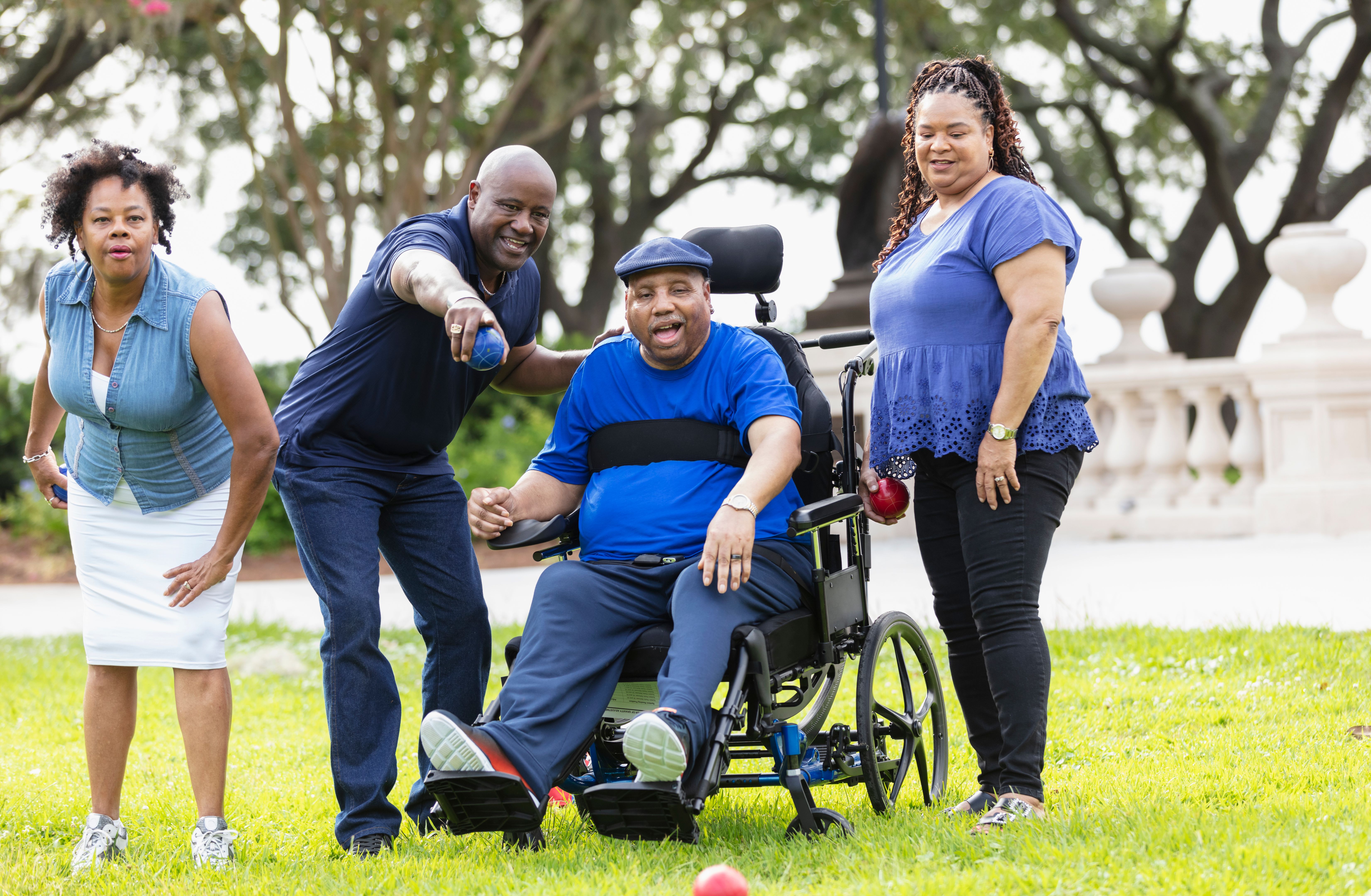 African-American seniors, man in wheelchair play bocce ball