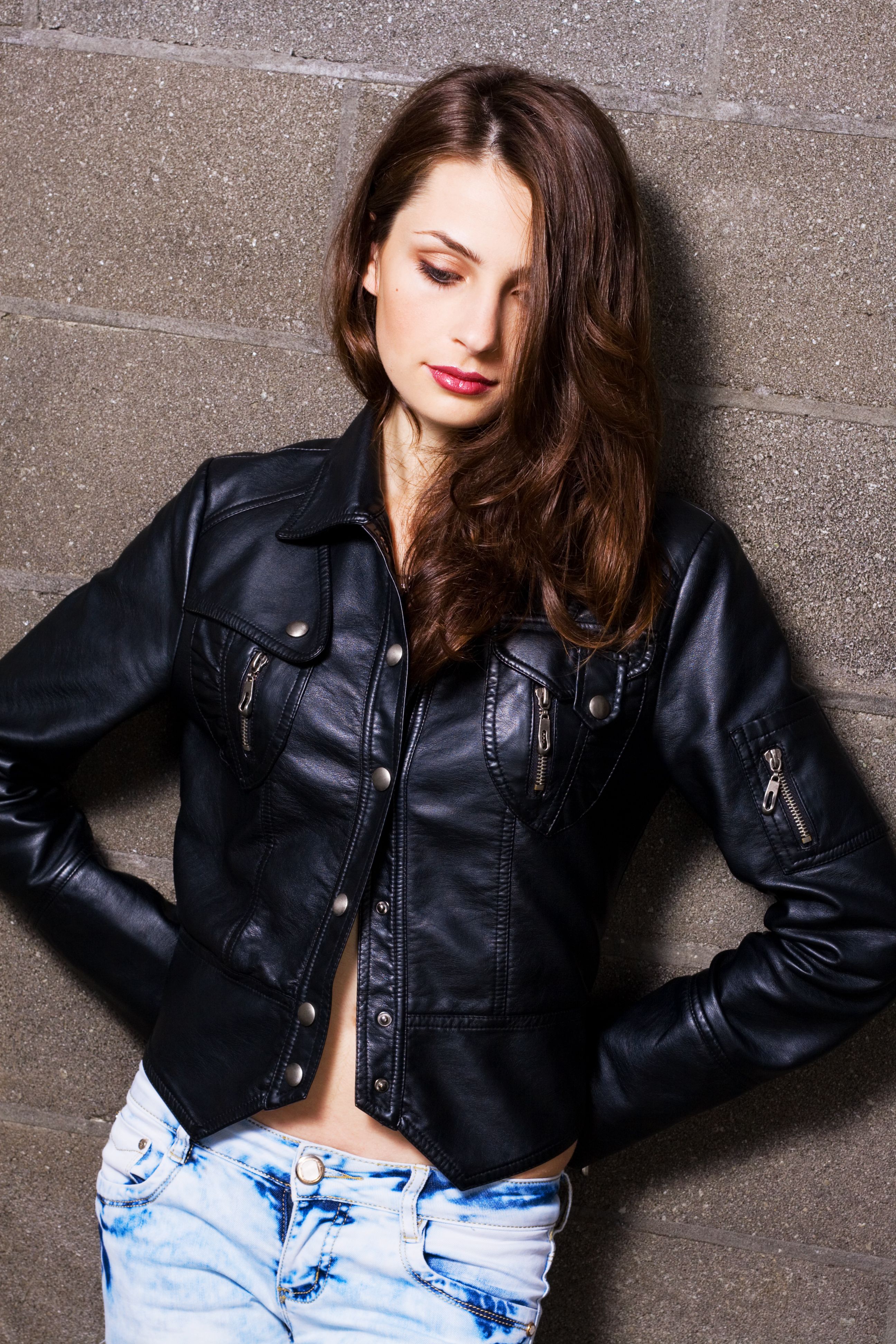 Pretty young woman in a black leather jacket