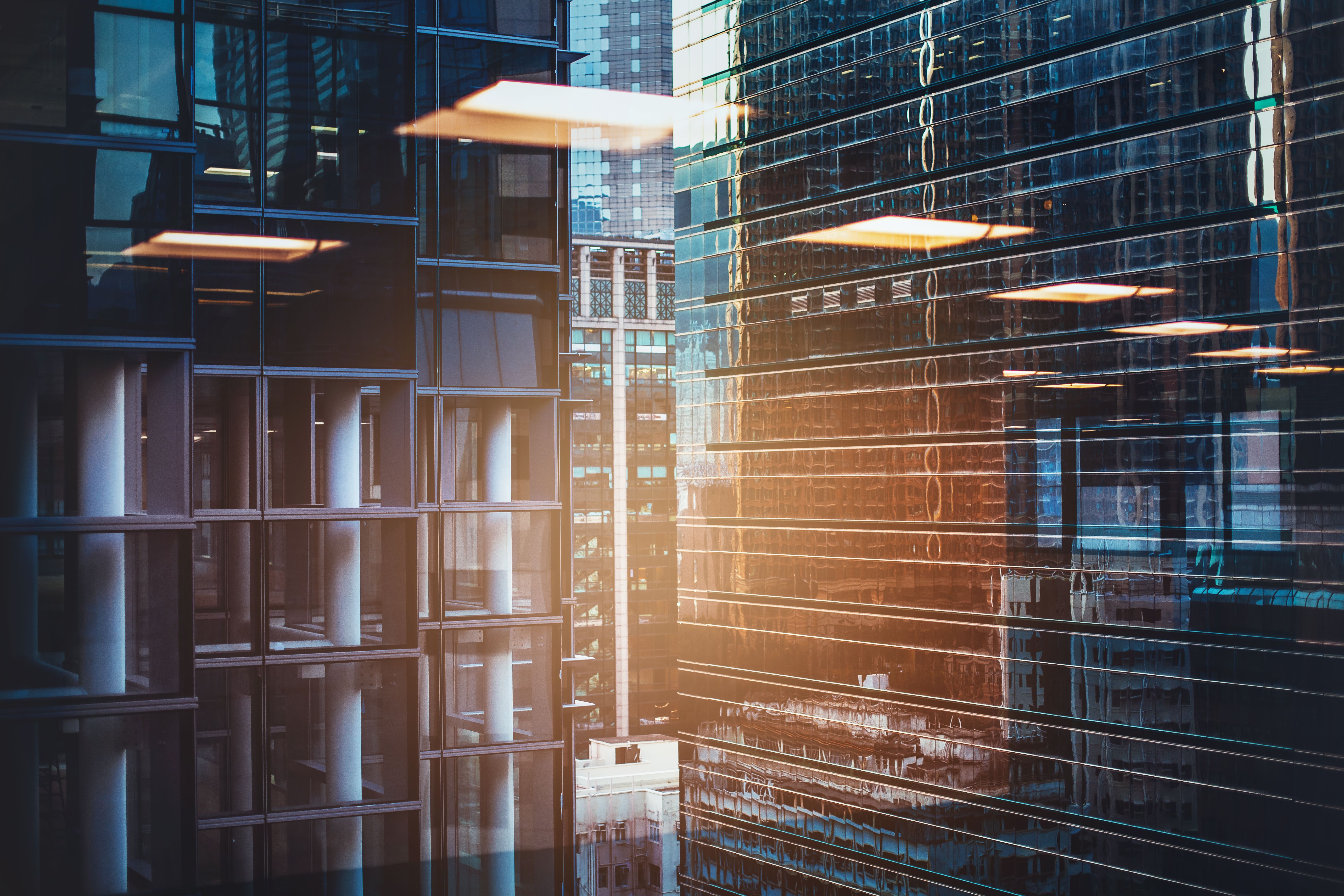 Abstract reflection of business office buildings in glass window in downtown urban area