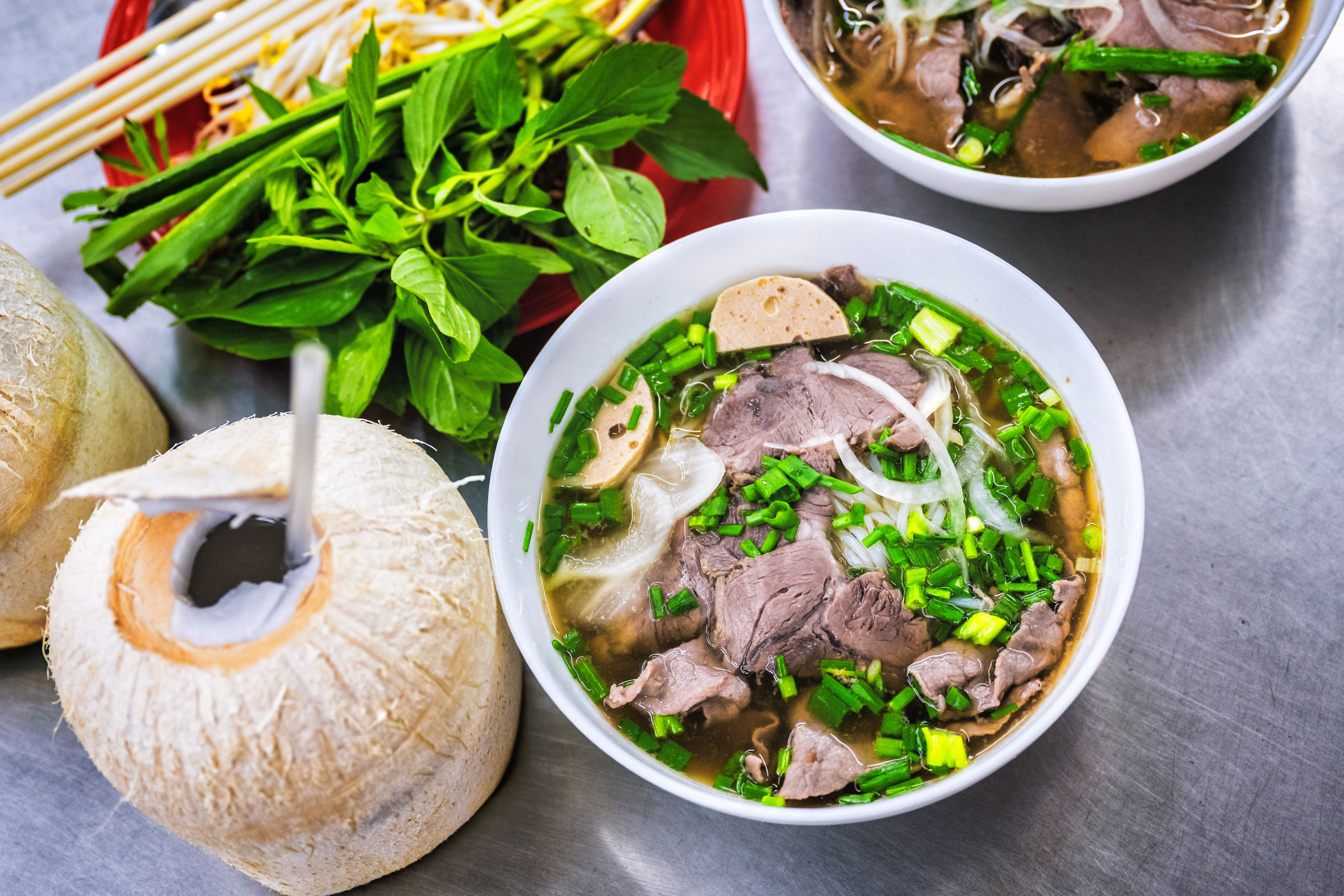 bowl of pho soup on metal table