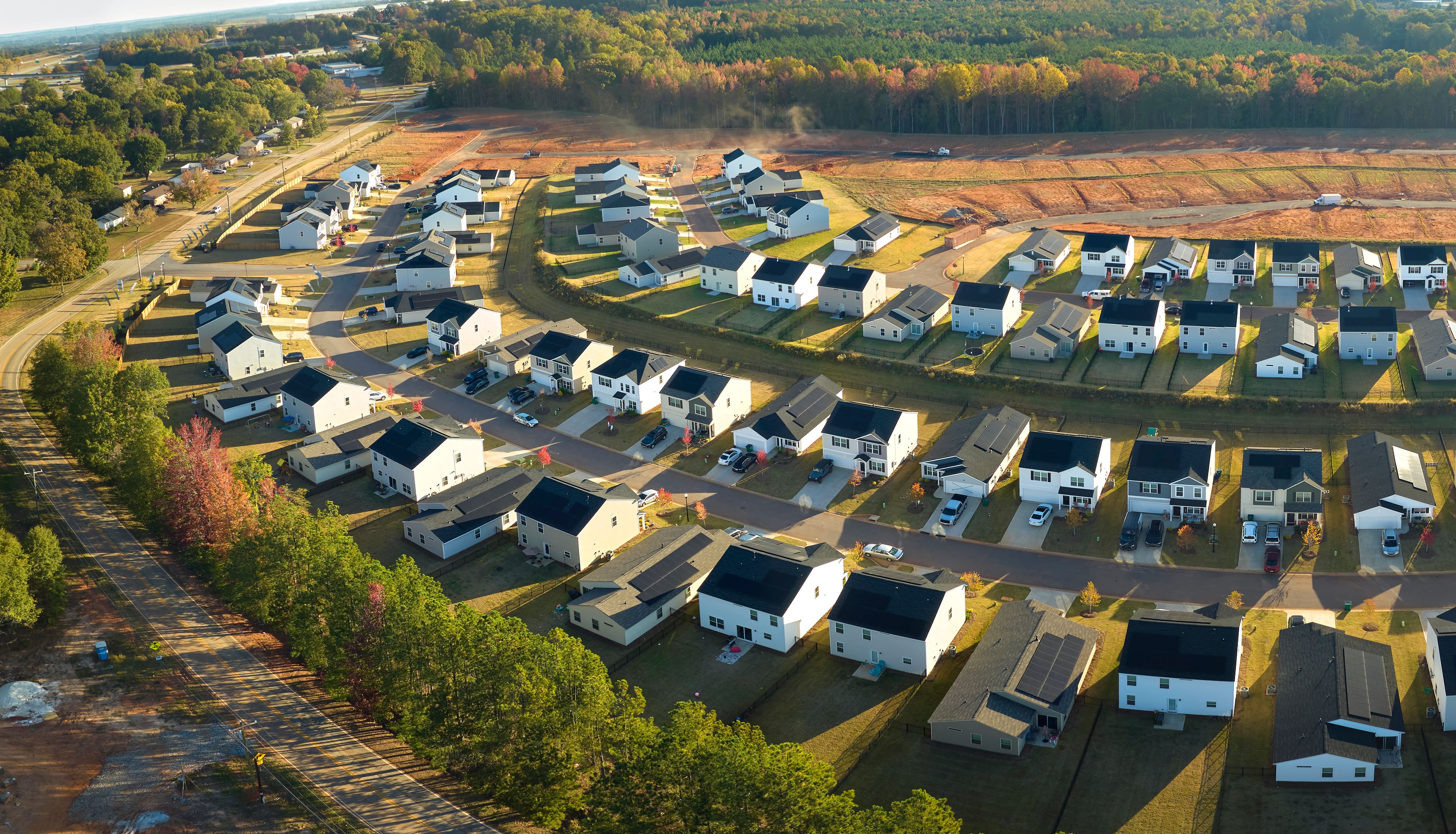 View from above of densely built residential houses in living area in South Carolina. American dream homes as example of real estate development in US suburbs View from above of densely built residential houses in living area in South Carolina. American dream homes as example of real estate development in US suburbs