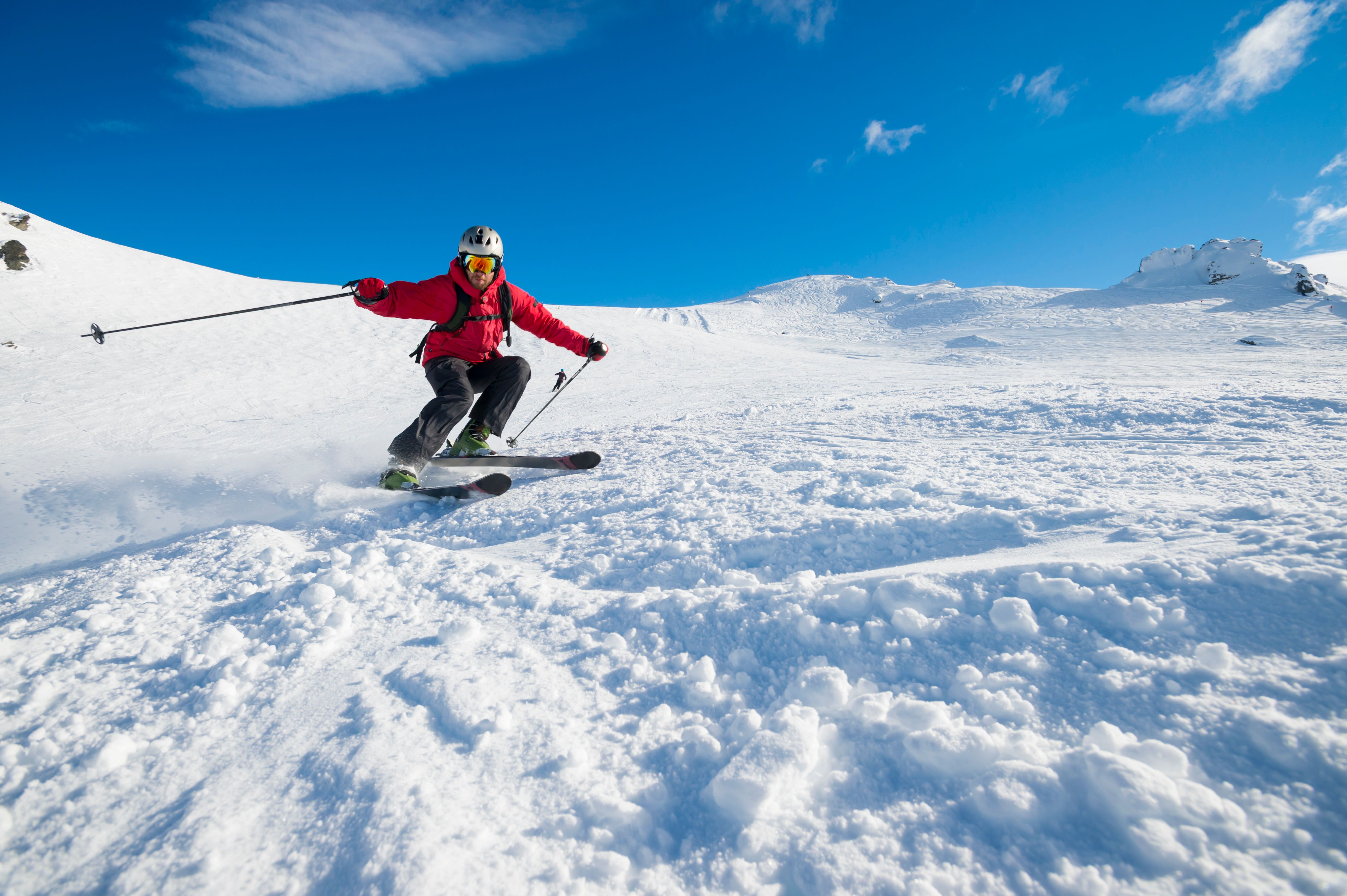 Skier turning on a blue sky day