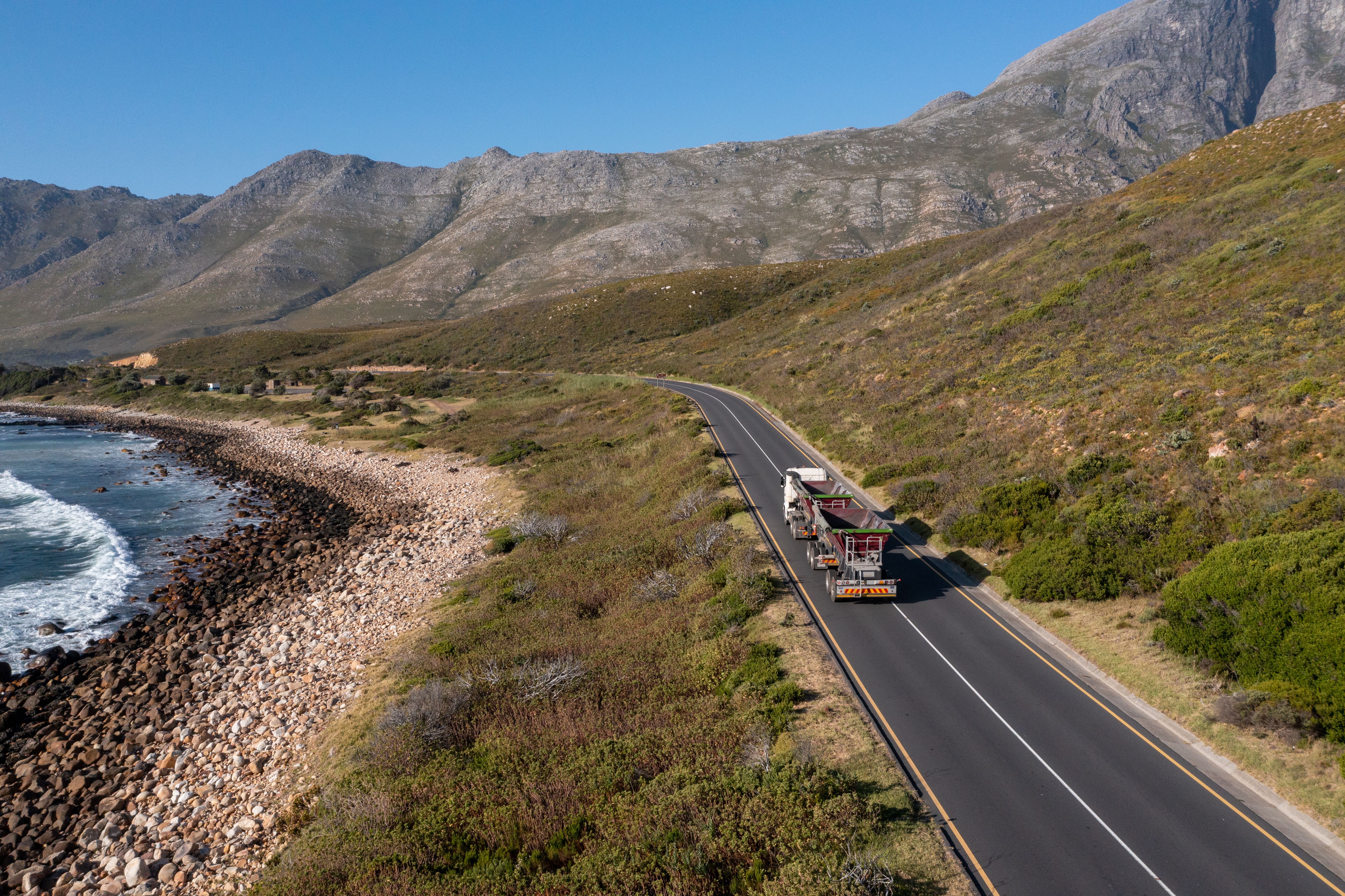 Truck driving along a scenic coastal road Truck driving along a scenic coastal road