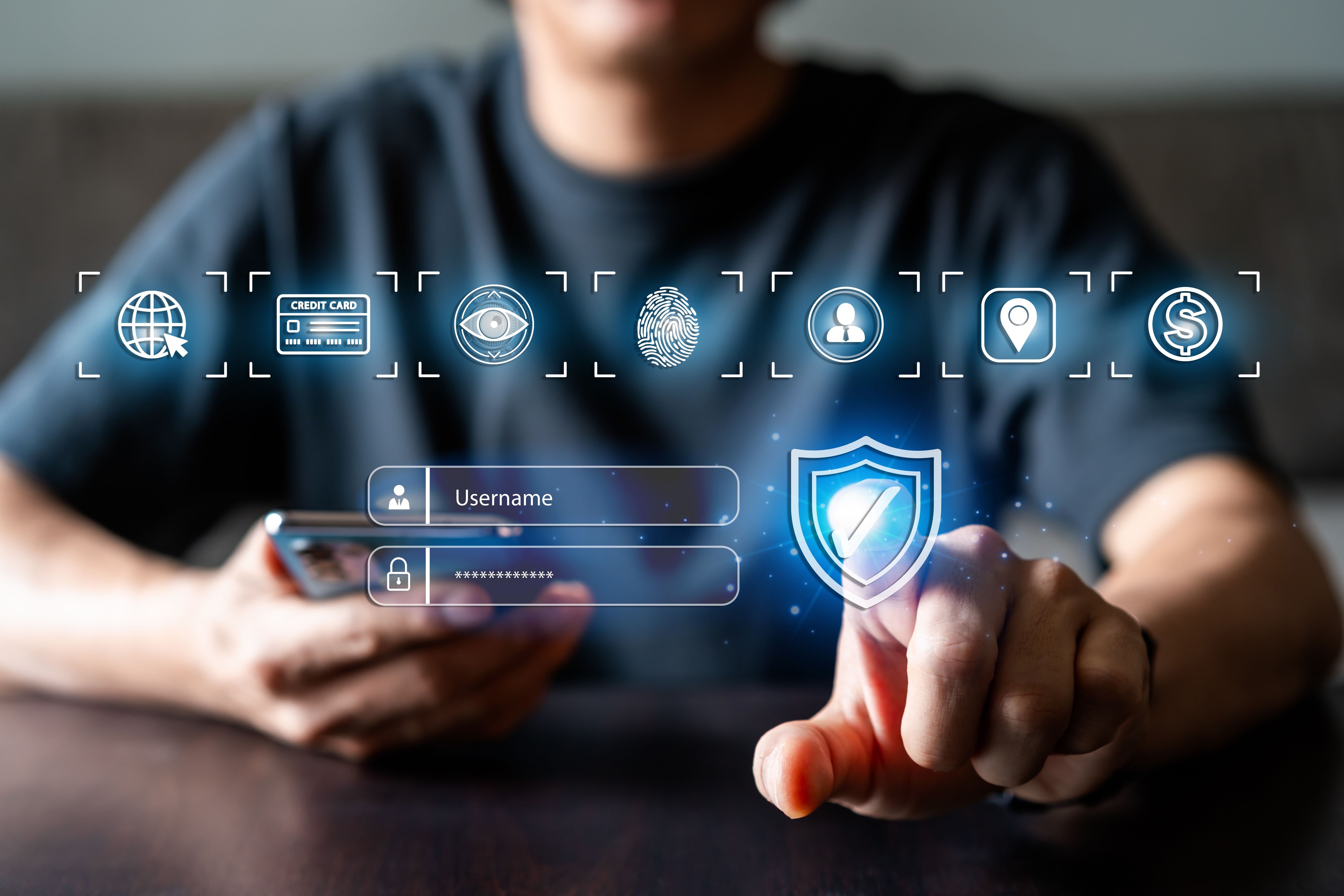 Young man using smart devices with global network connection and cyber security business data protection technology