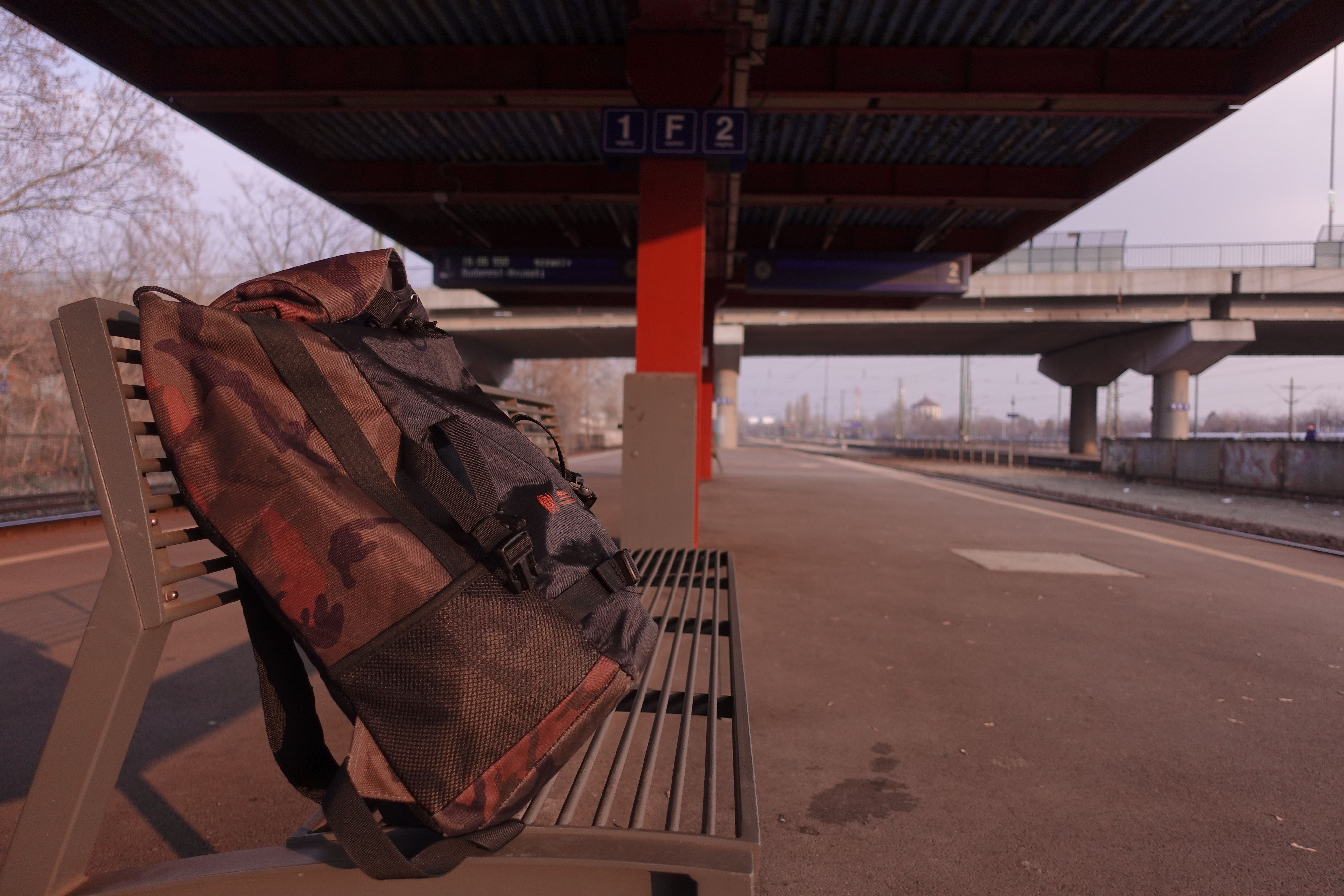 Solitary backpack sitting on a bench without its owner
