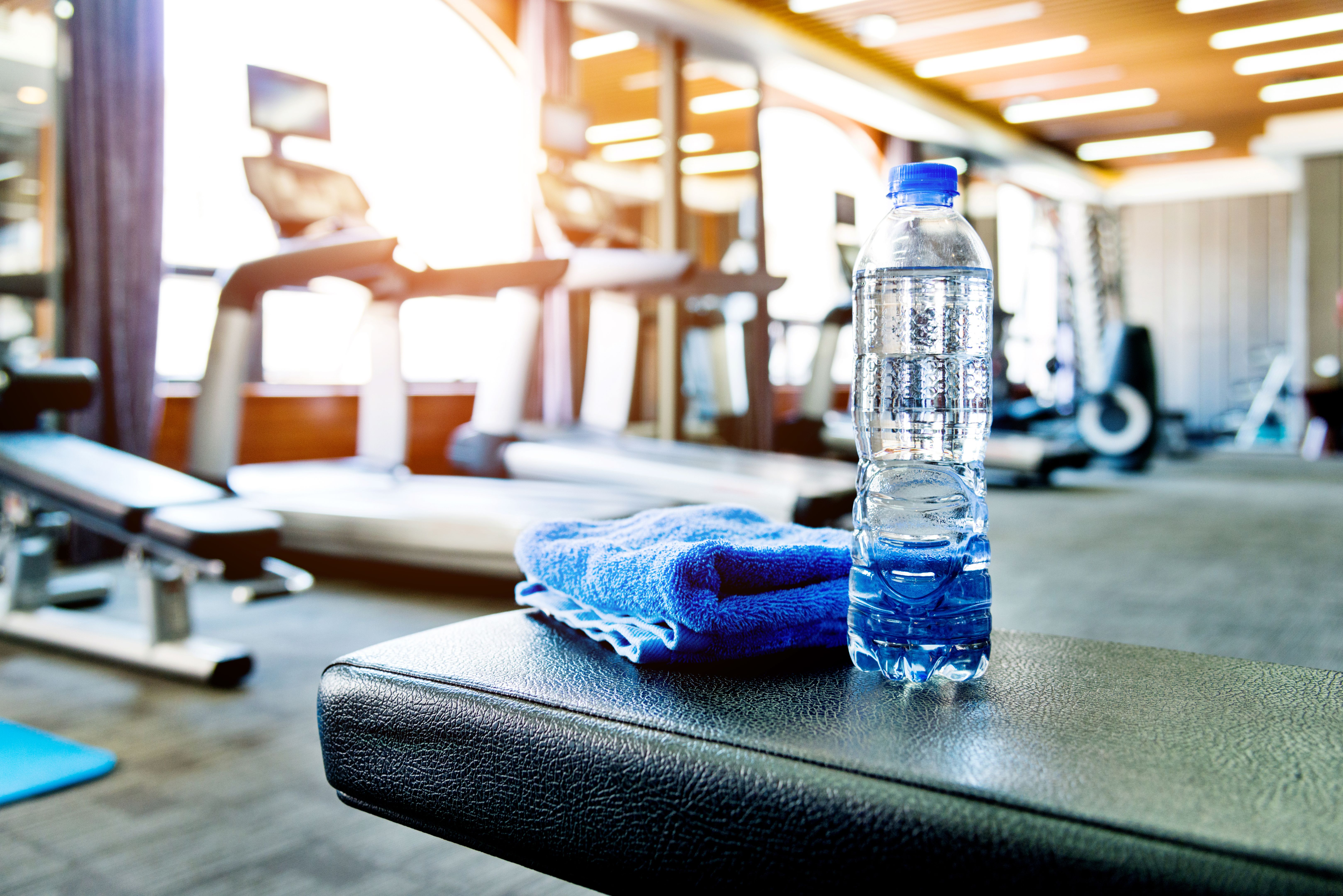 Towel and a bottle of water in gym Towel and a bottle of water in gym