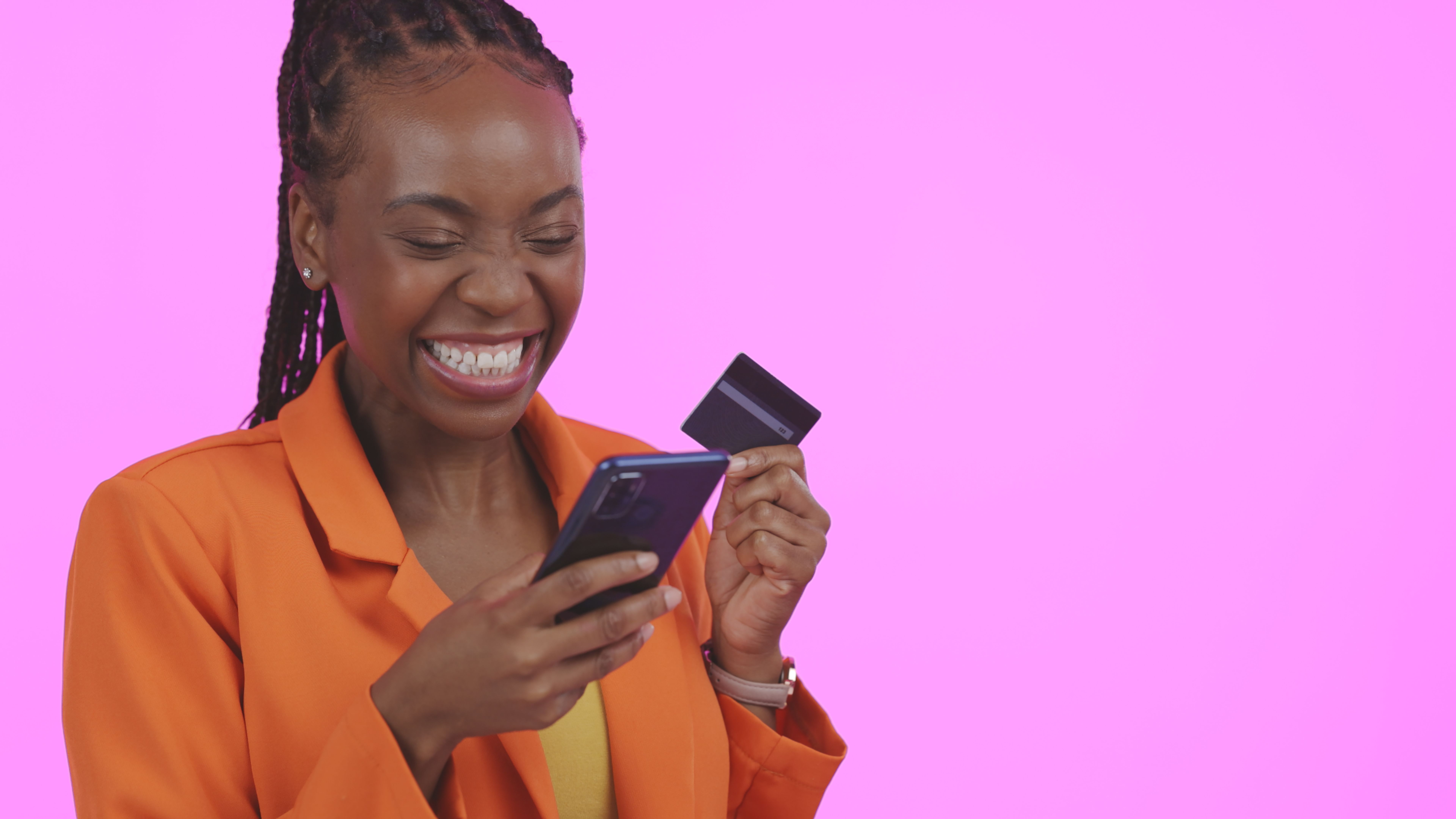Business woman, phone and credit card for online shopping, e commerce sale or fintech payment in studio. Excited African person or winner for mobile banking, transaction or order on a pink background Business woman, phone and credit card for online shopping, e commerce sale or fintech payment in studio. Excited African person or winner for mobile banking, transaction or order on a pink background