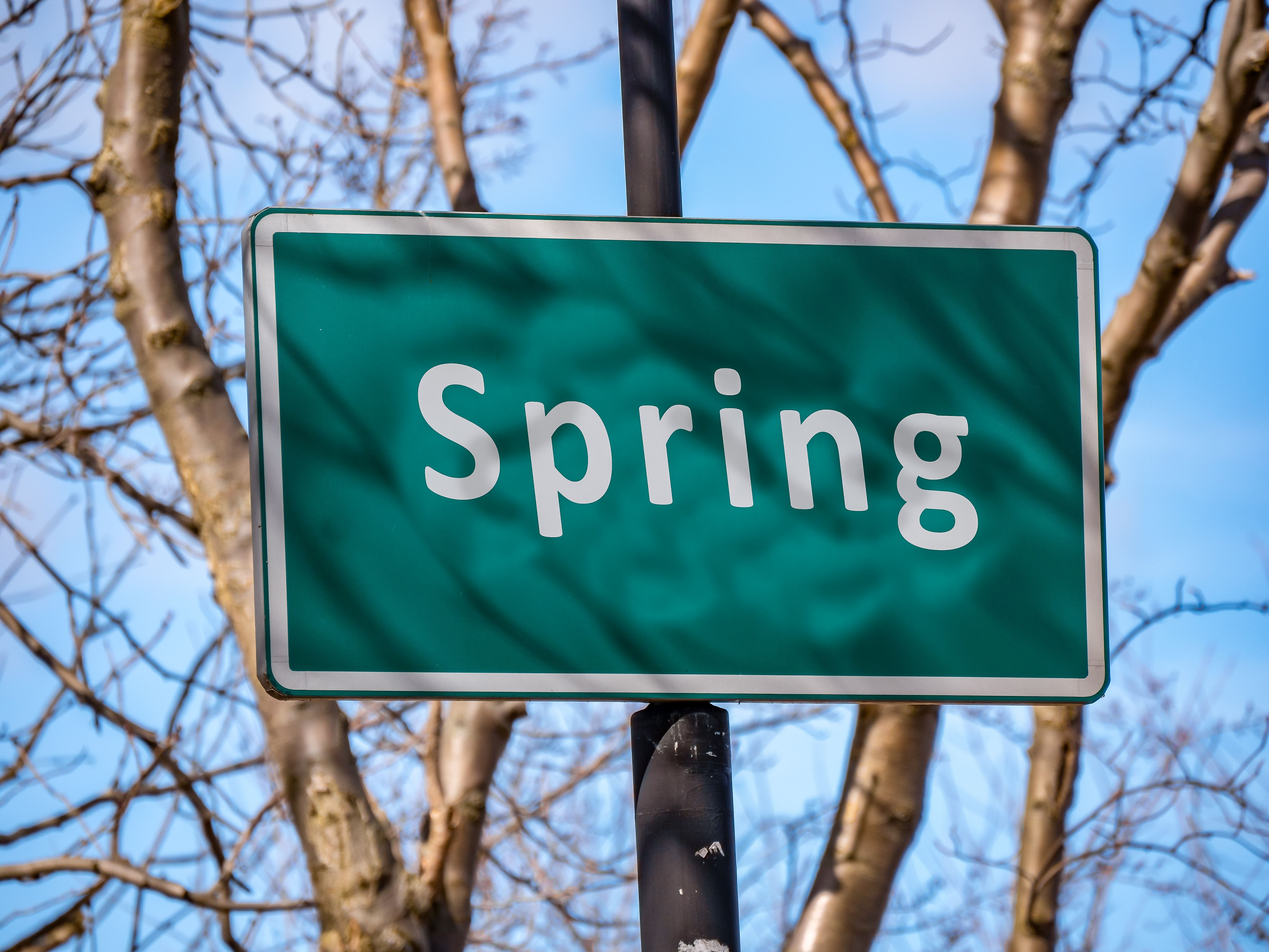 Road sign with Spring text on it - concept.
