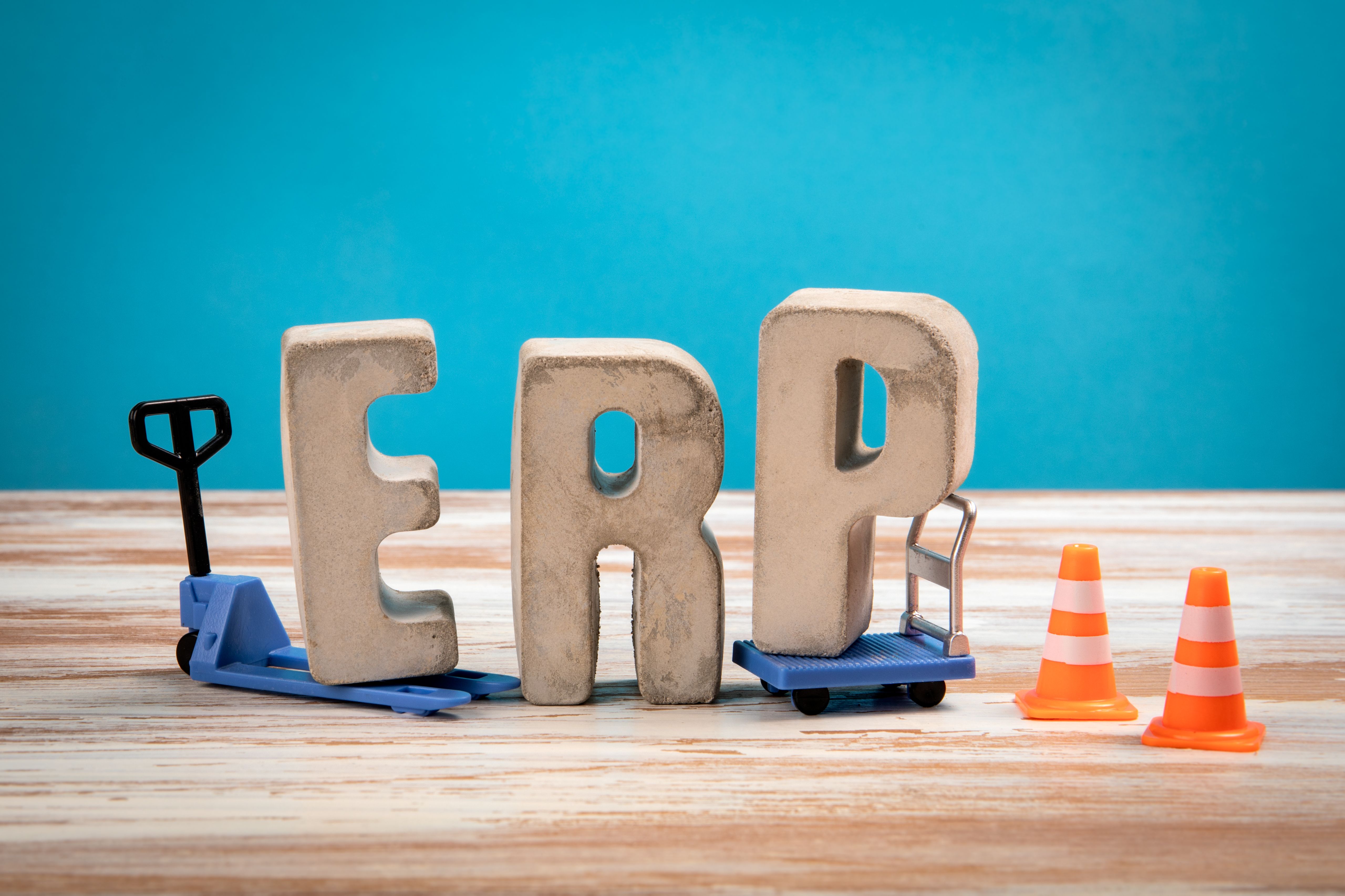 ERP. Concrete Alphabet Letters on a White Wooden and Blue Background