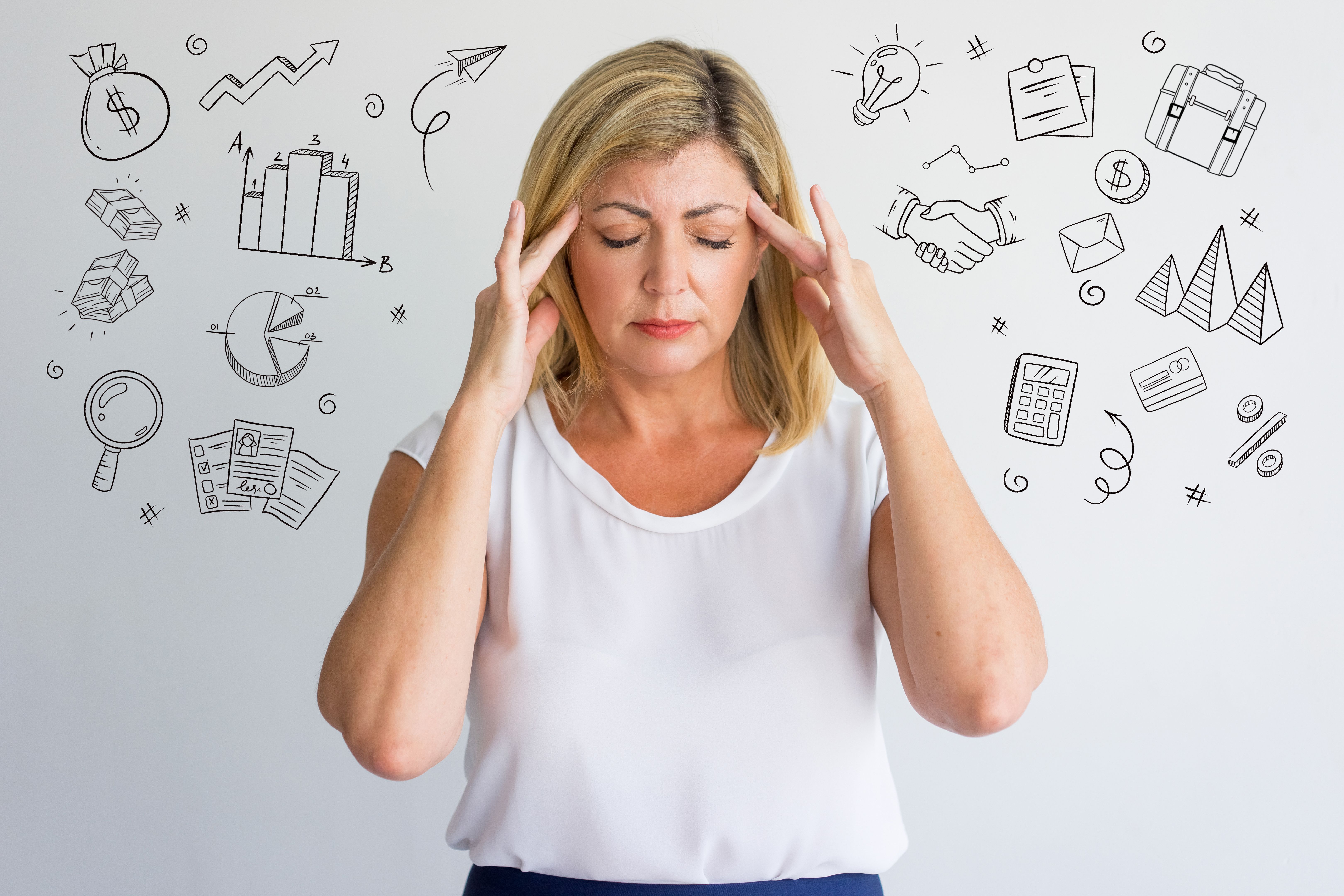 Stressful woman with headache and hand drawn business sketches Stressful woman with headache and hand drawn business sketches