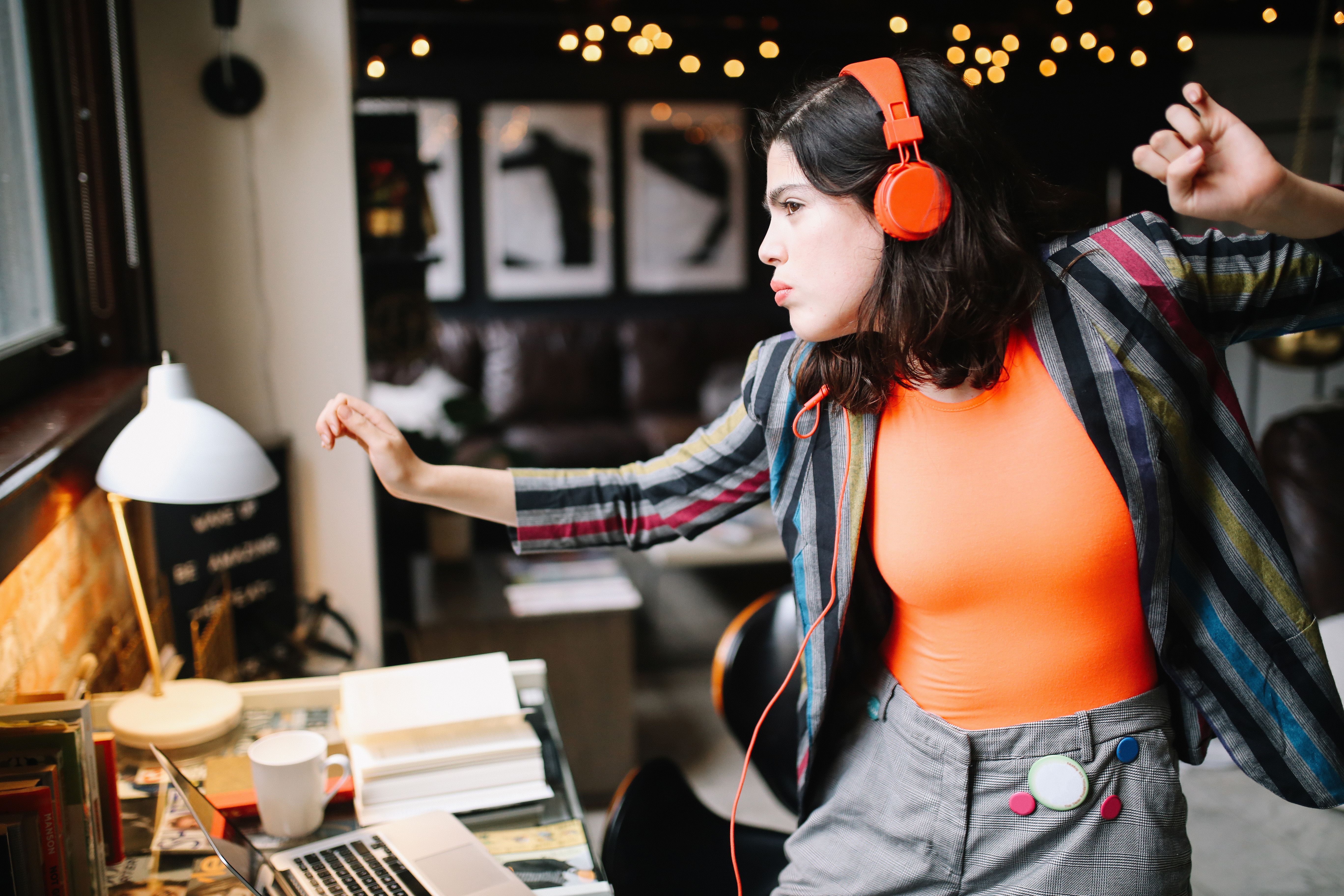 young millennial dancing to the music in her Downtown Los Angeles apartment young millennial dancing to the music in her Downtown Los Angeles apartment