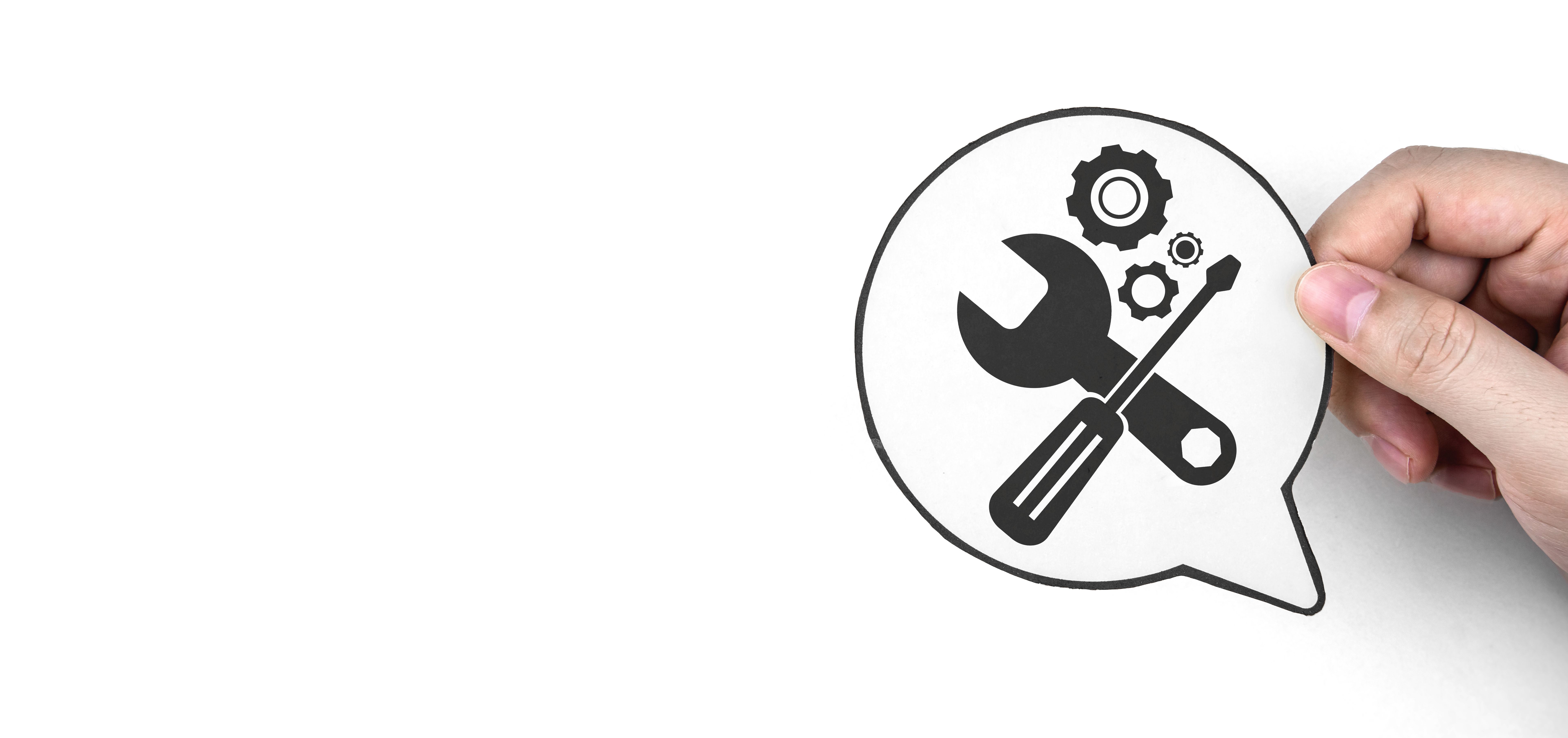 Hand holding paper with gear icon and mechanic tools. Concept of maintenance, process of maintaining and repairing equipment.