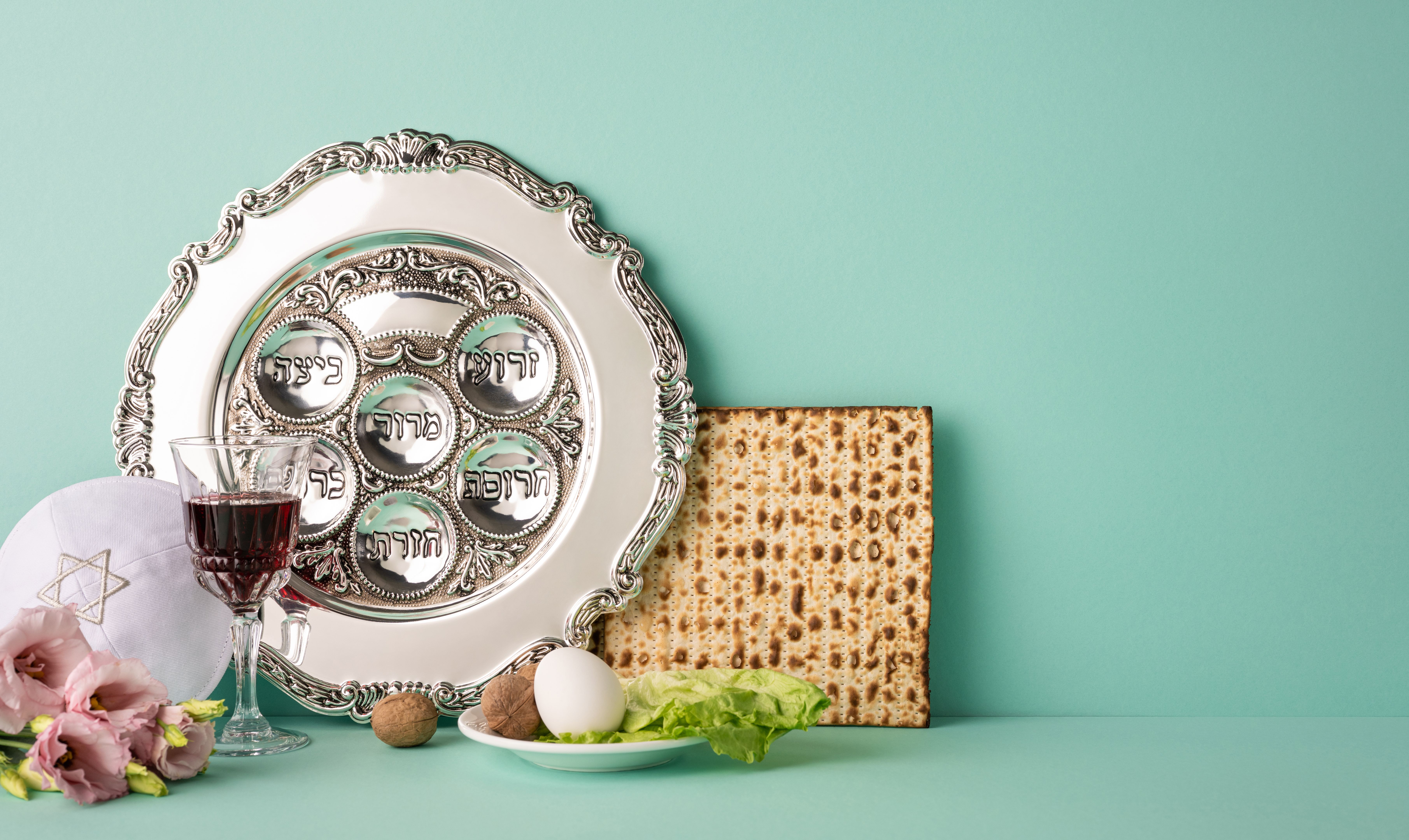 Traditional side view Jewish Passover celebration featuring a Seder plate, Matzo bread, and symbolic items