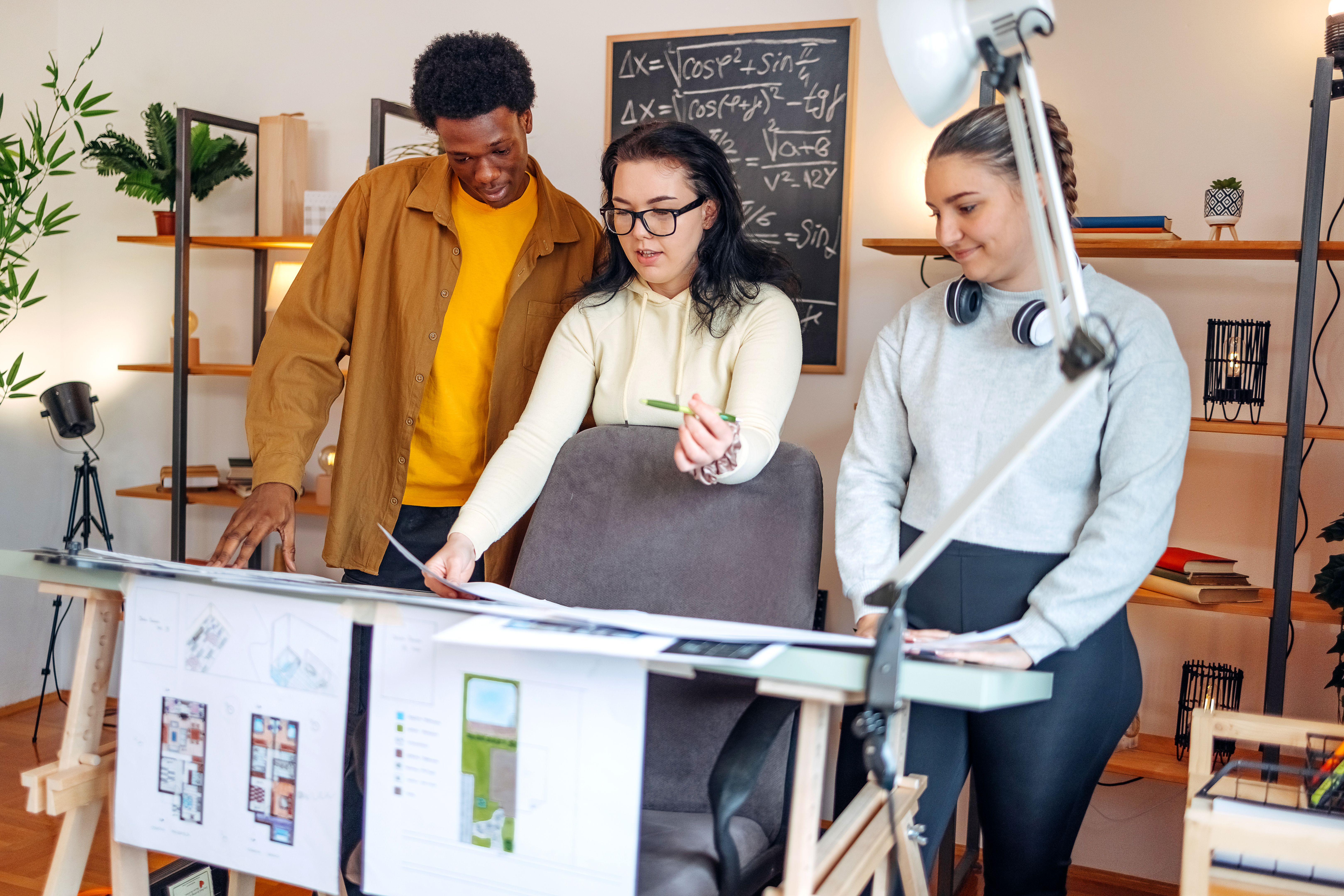 Group of young people working on project together at home Group of young people working on project together at home