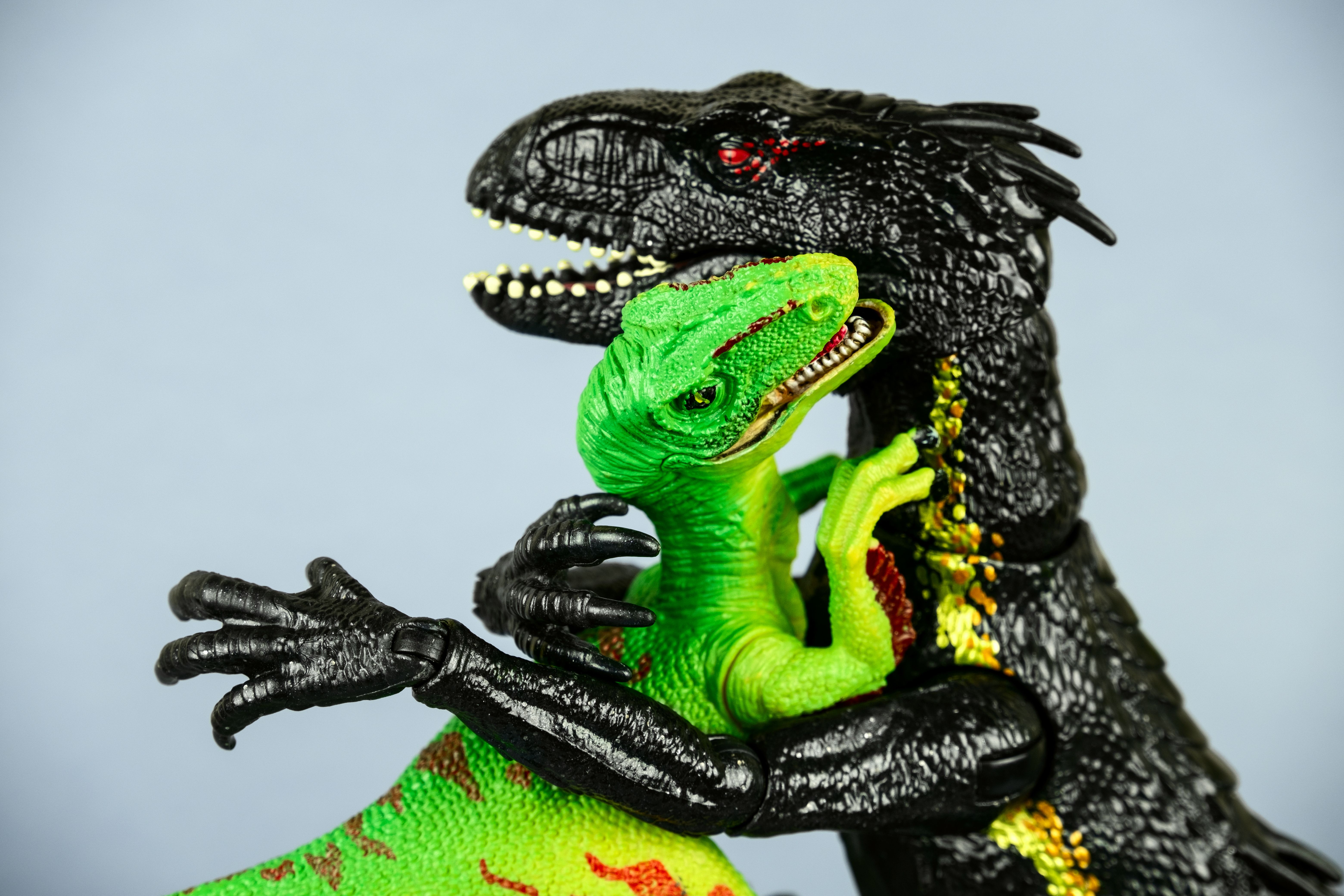 plastic dinosaurs hugging each other