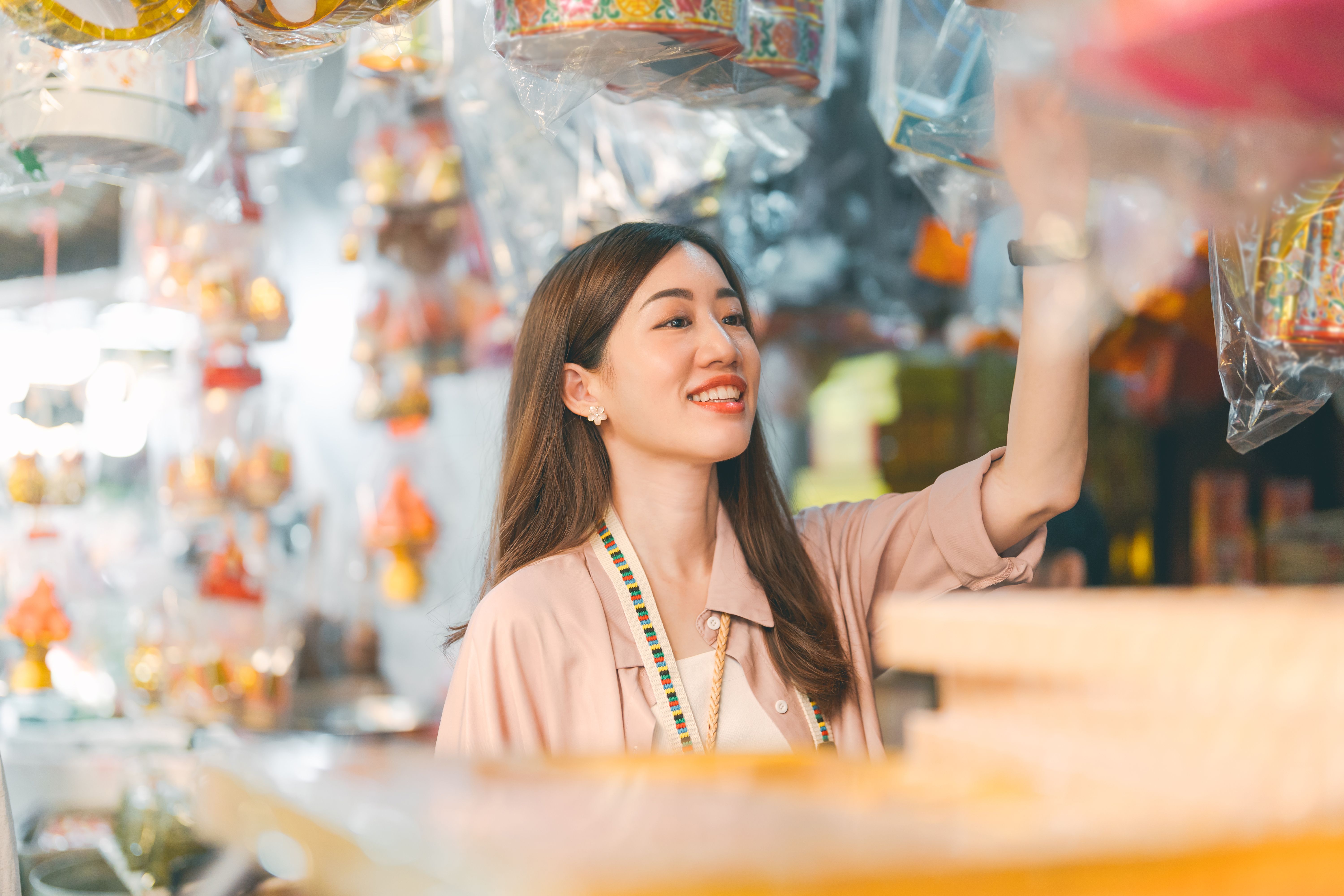 Woman solo travel at chinese local culture market product at shop vendor Woman solo travel at chinese local culture market product at shop vendor