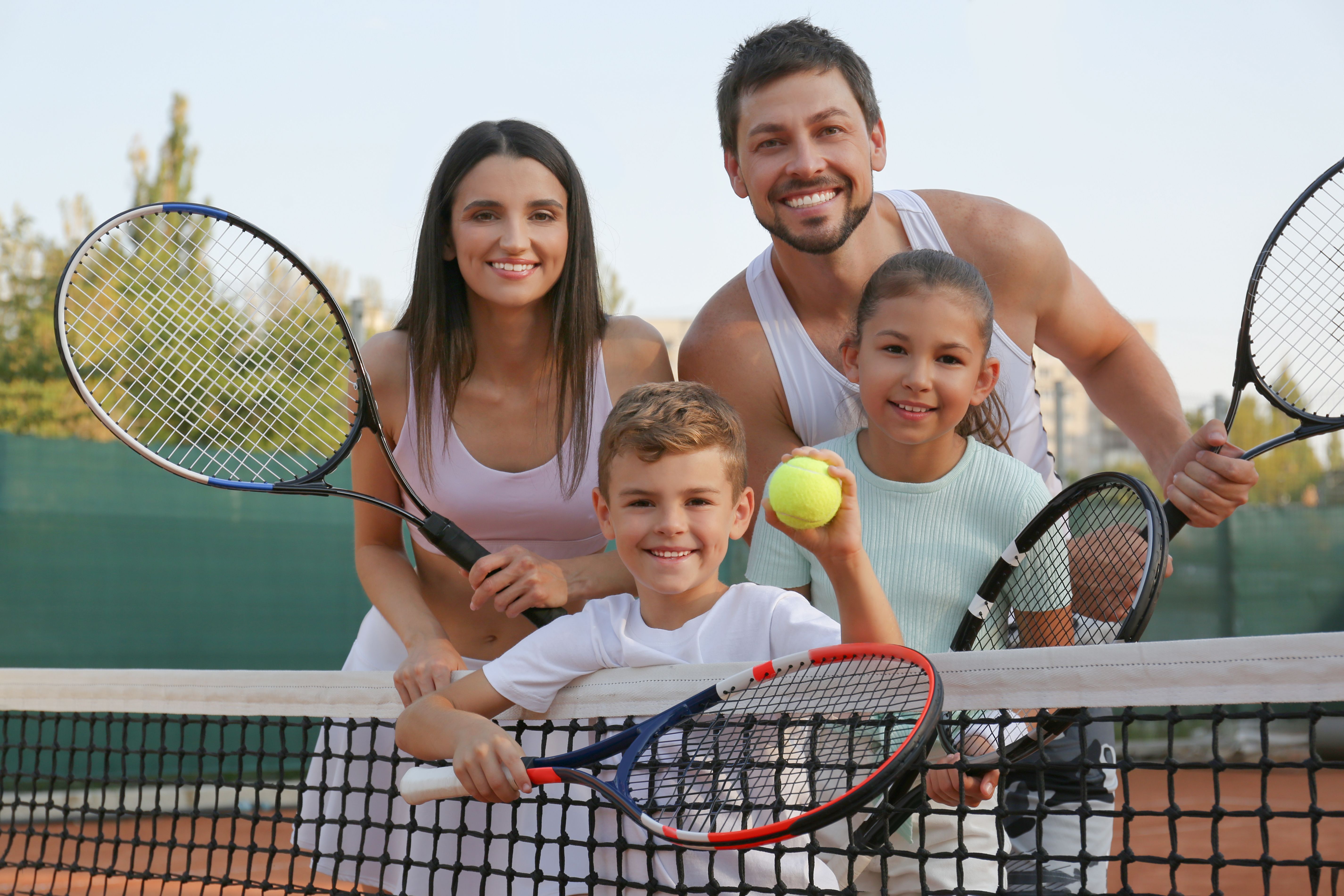 family playing tennis