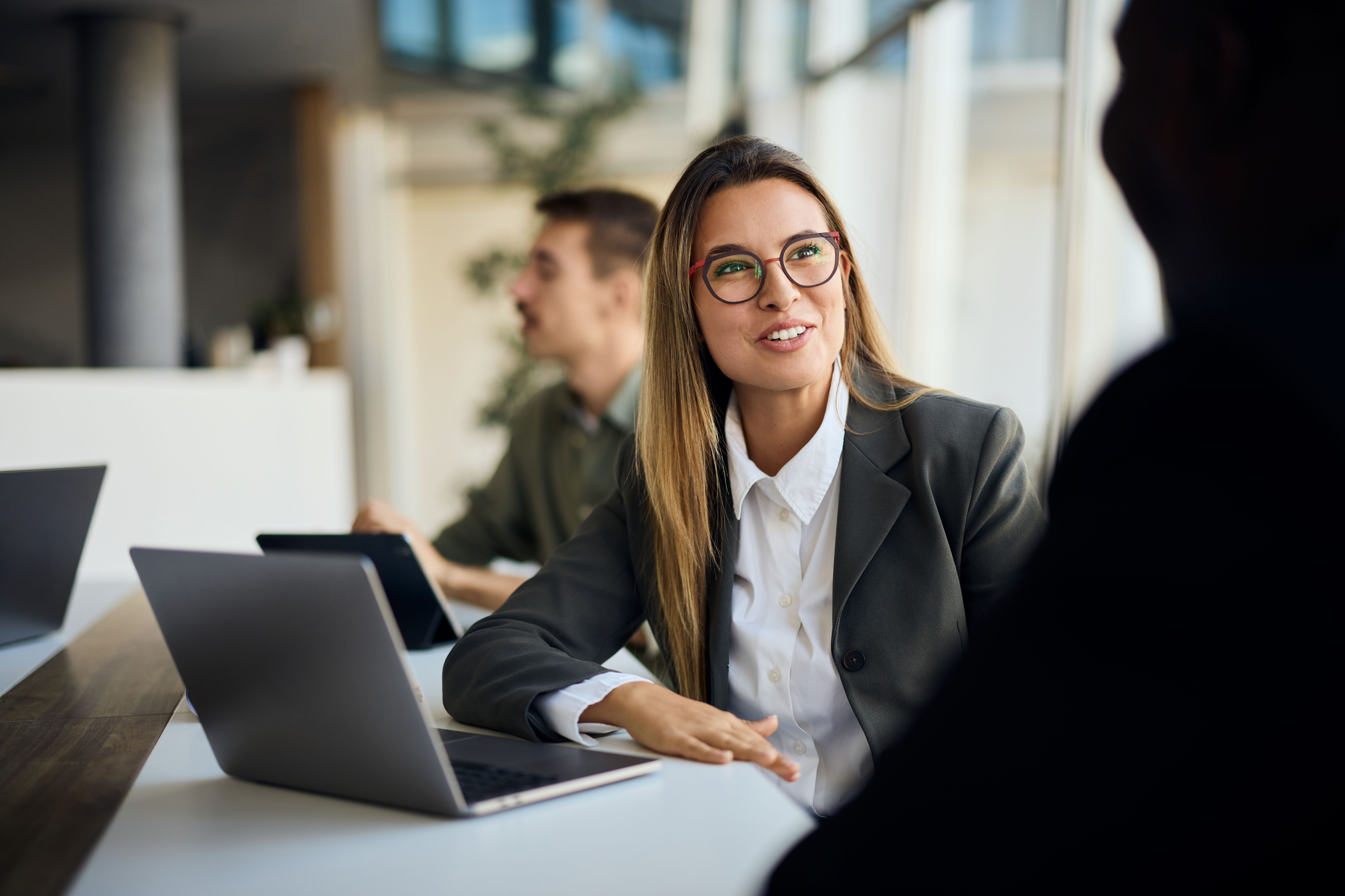 Professional Businesswoman Engaging in a Meeting in a Collaborative Office Environment