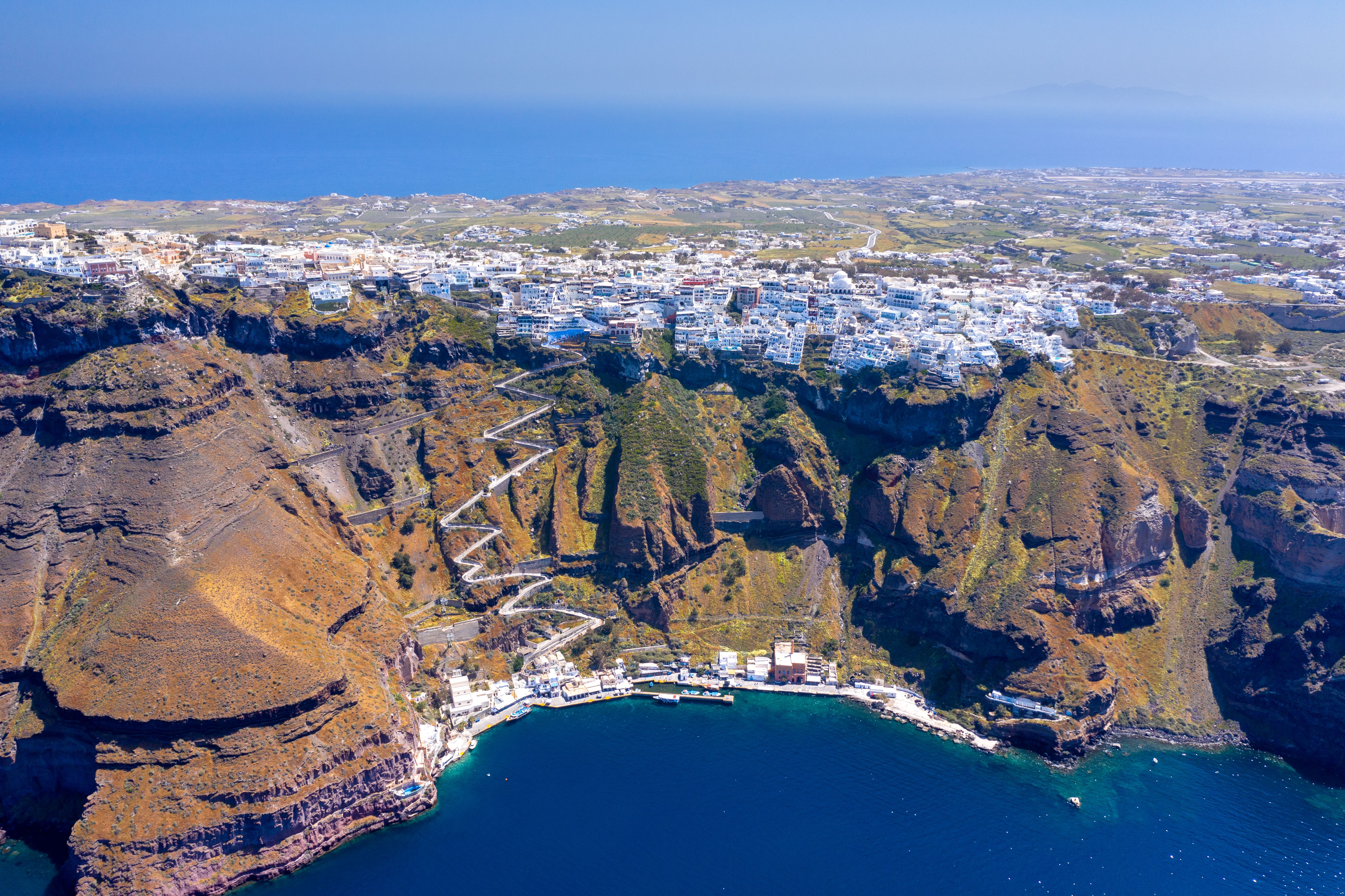 Fira town, with view of caldera, volcano and cruise ships, Santorini, Greece.
