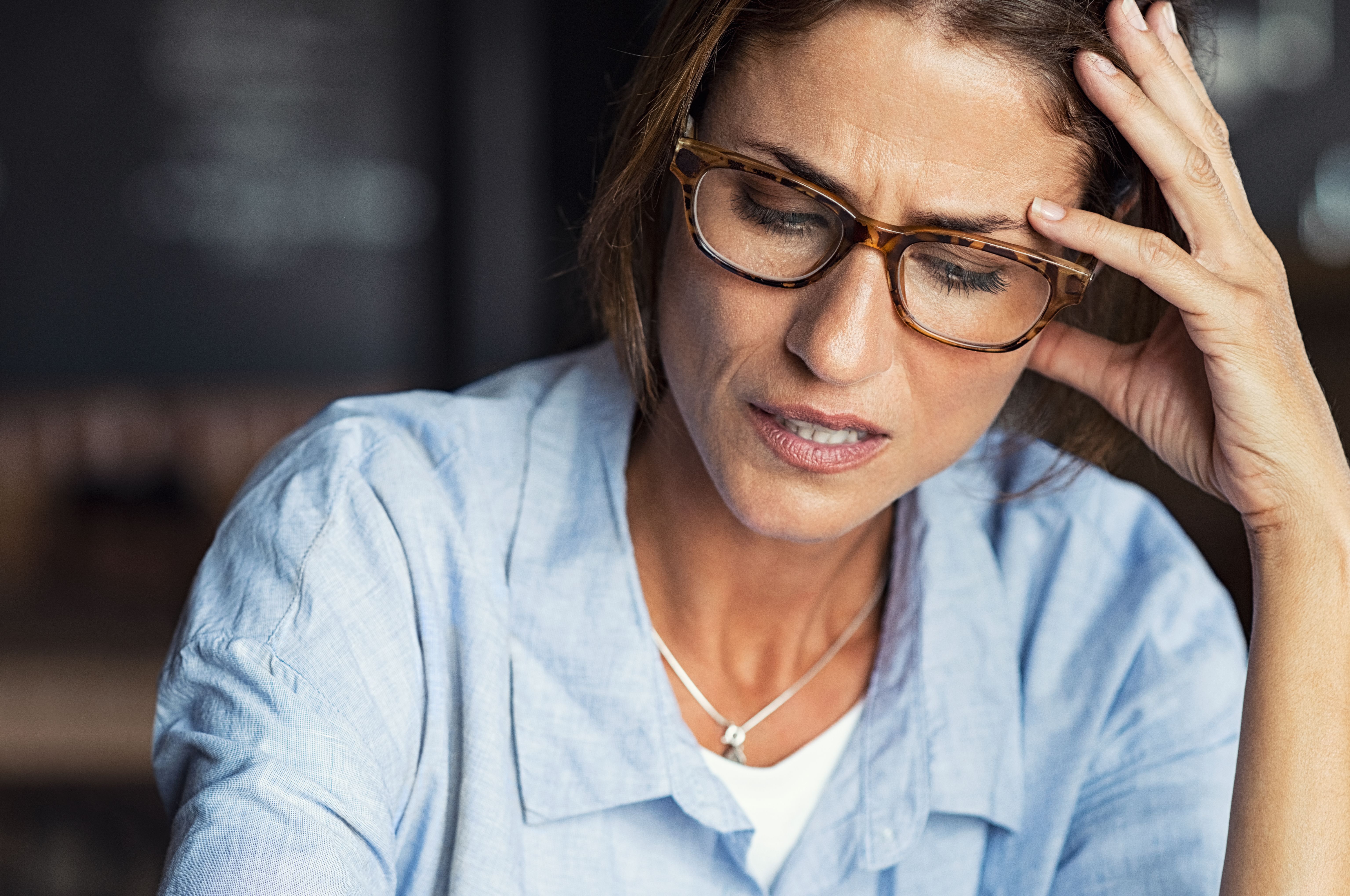 Stressed woman wearing eyeglasses