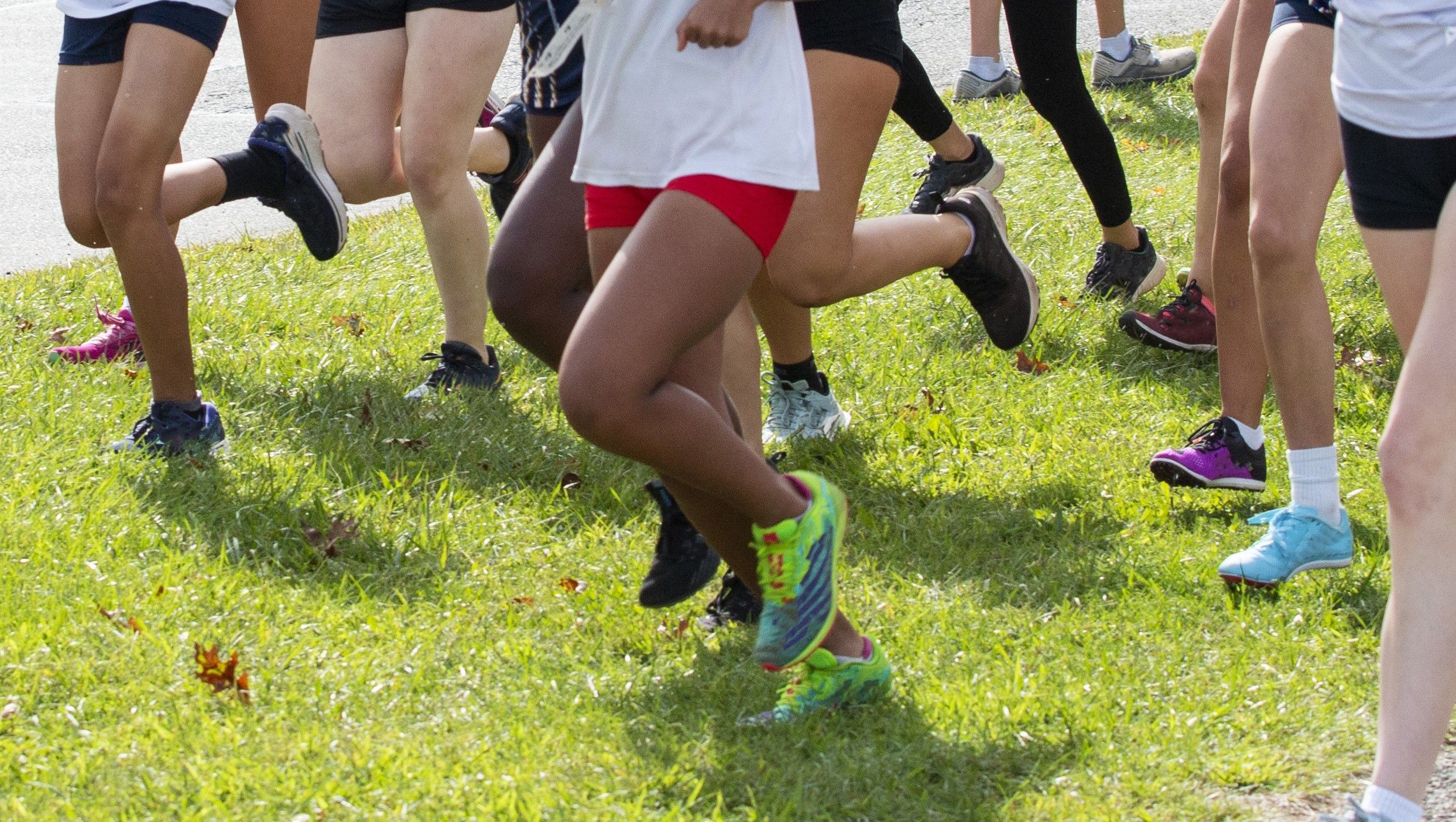 Young girls running in a high school cross country 5K race Young girls running in a high school cross country 5K race